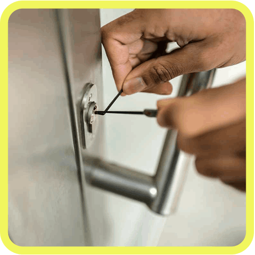 Locksmith Using Specialized Tools To Unlock A Silver Business Door Close-Up.