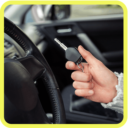 Close-Up Of Woman's Hand Holding A Car Key In Vehicle Interior.