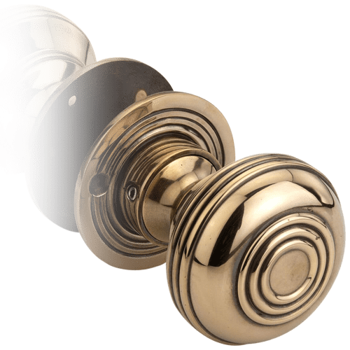A Close-Up View Of A Round Gold Antique Door Knob.
