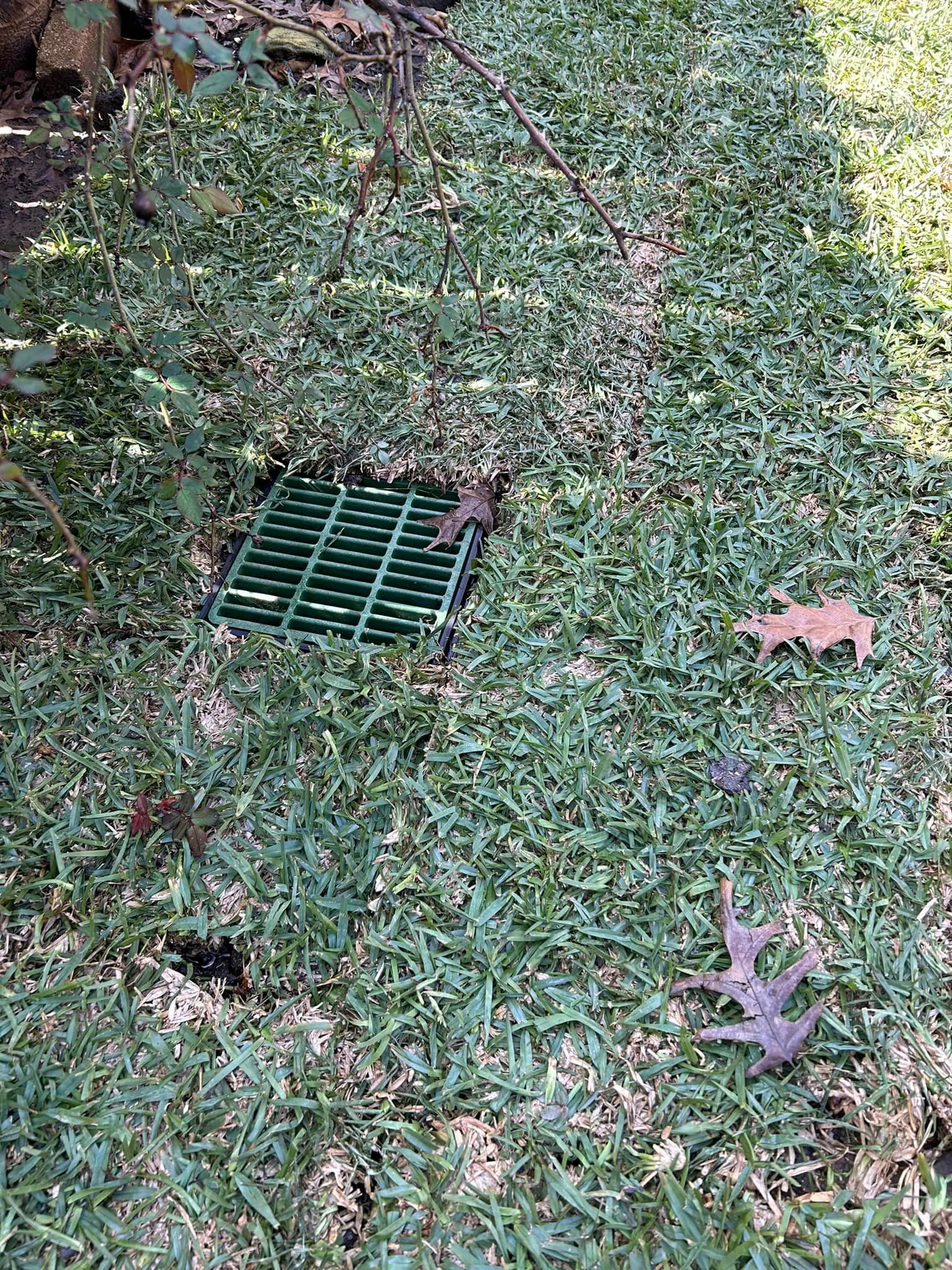 A Green Drain Cover Is Sitting in The Grass - Collinsville, TX - L5 Irrigation