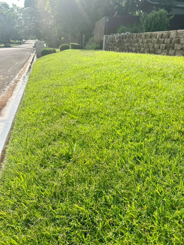 A Lush Green Lawn Along the Side of A Road Next to A Stone Wall - Collinsville, TX - L5 Irrigation