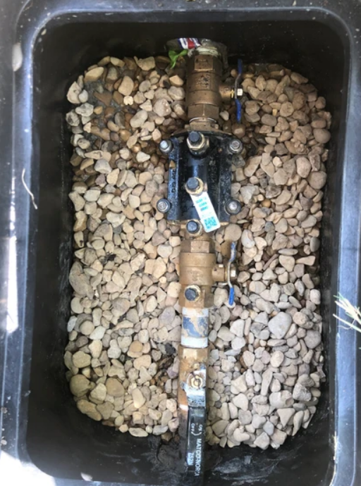 A Pipe is Sitting in a Box Filled With Rocks - Collinsville, TX - L5 Irrigation