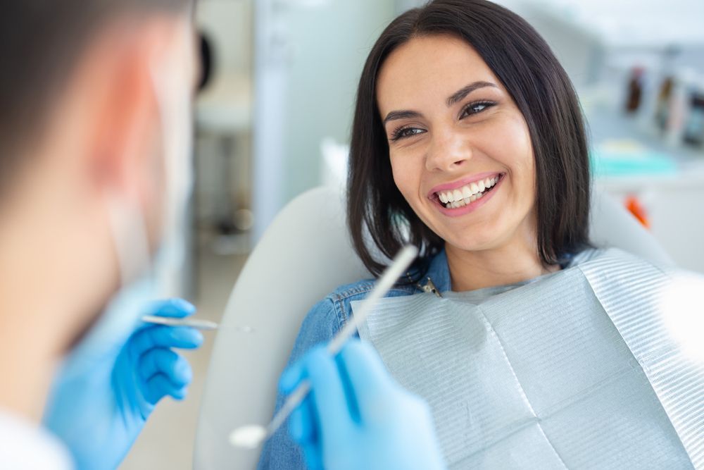 Dentist treating a smiling patient