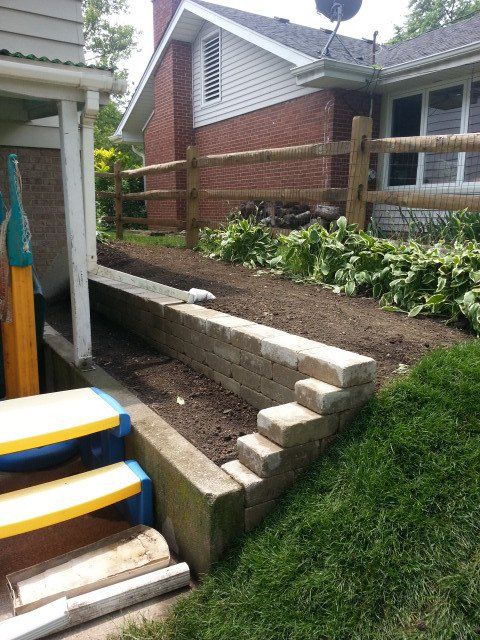 A house with a wooden fence and stairs in front of it