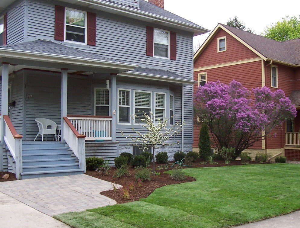 A house with purple flowers in front of it