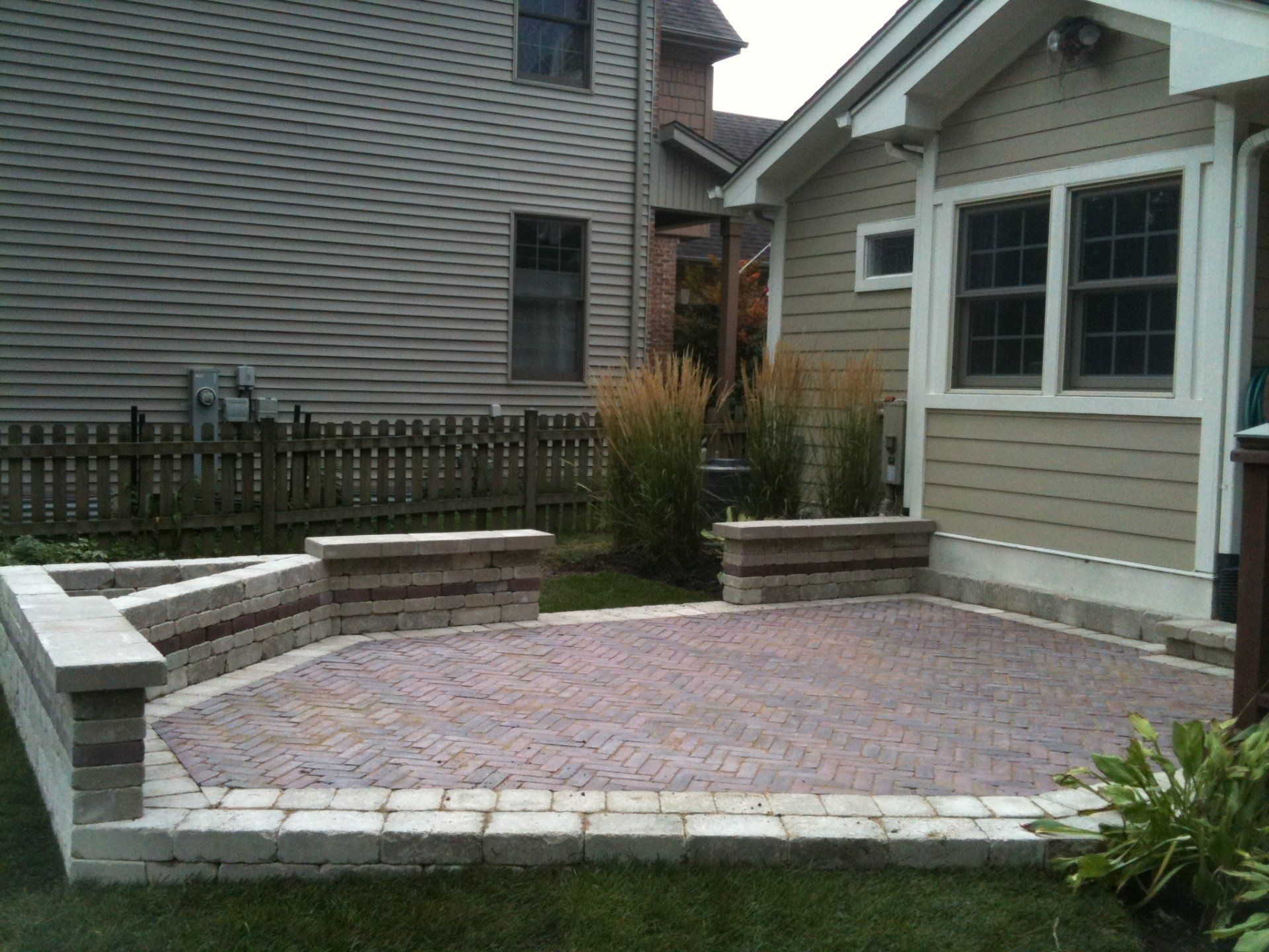 A house with a brick patio in front of it