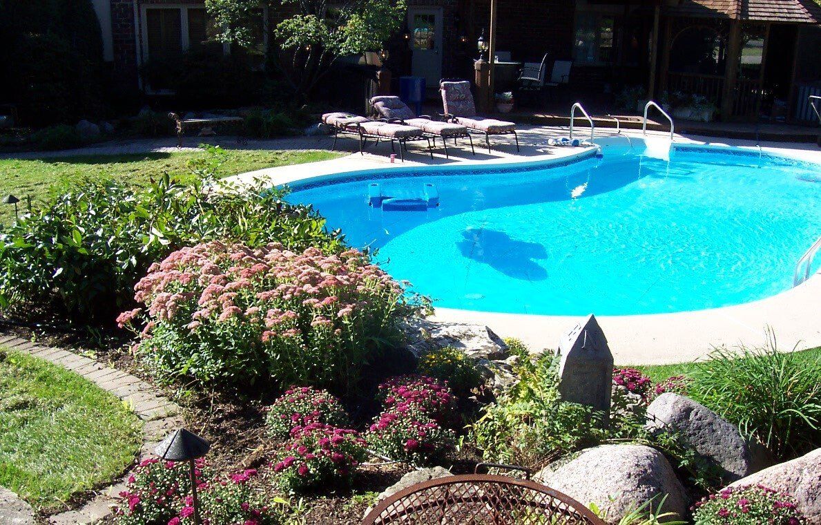 A large swimming pool in the backyard of a house