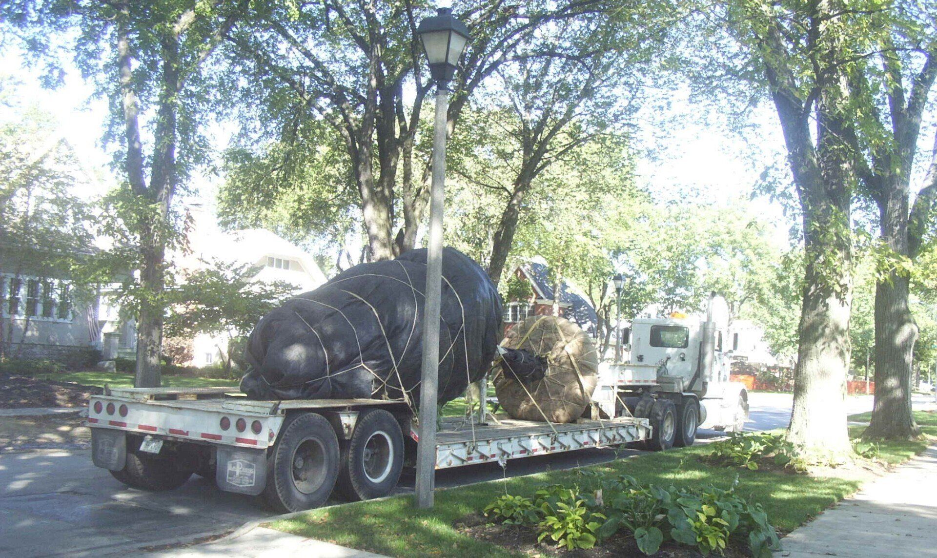 A large black object is on the back of a semi truck