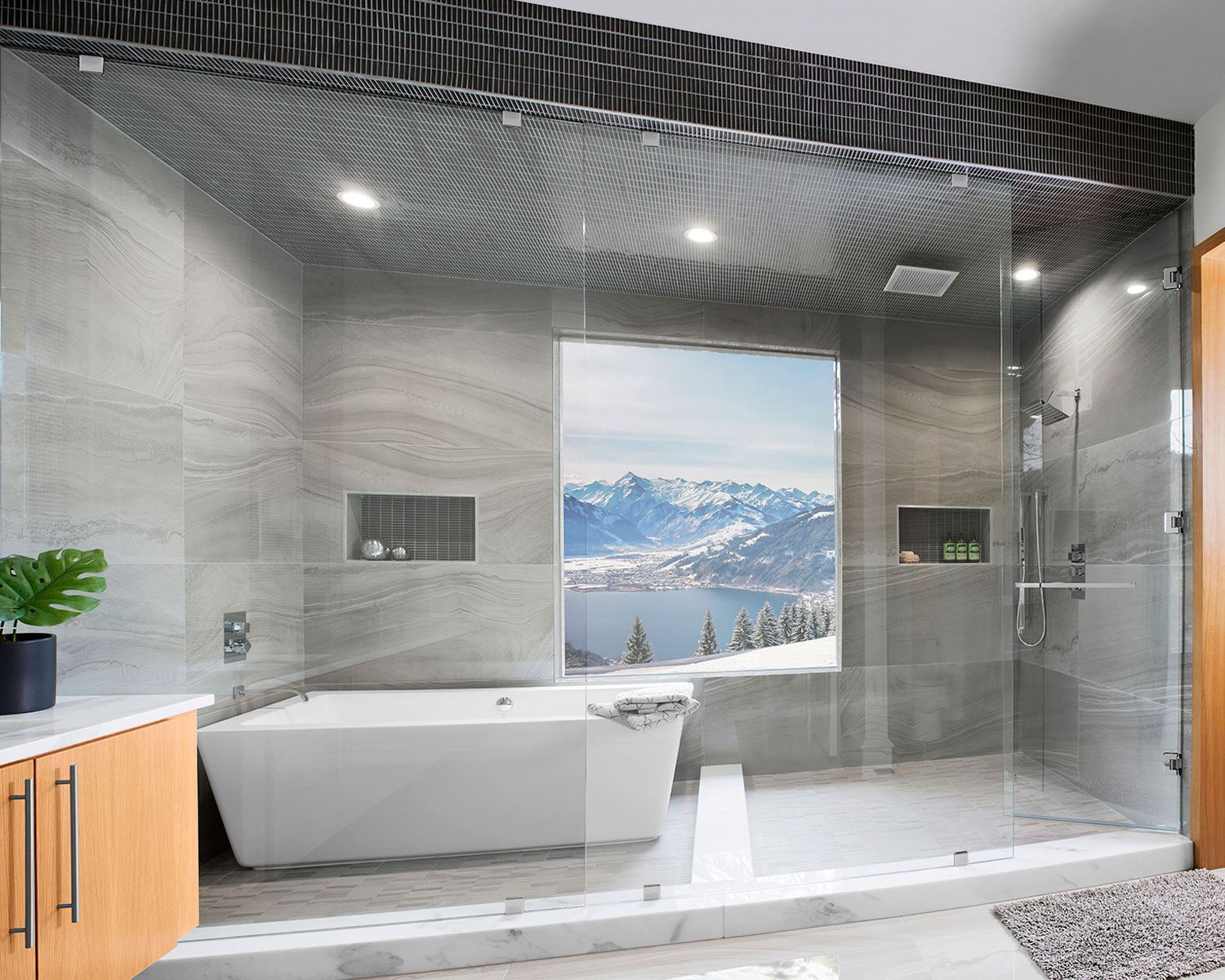 A bathroom with a sink and a walk in shower