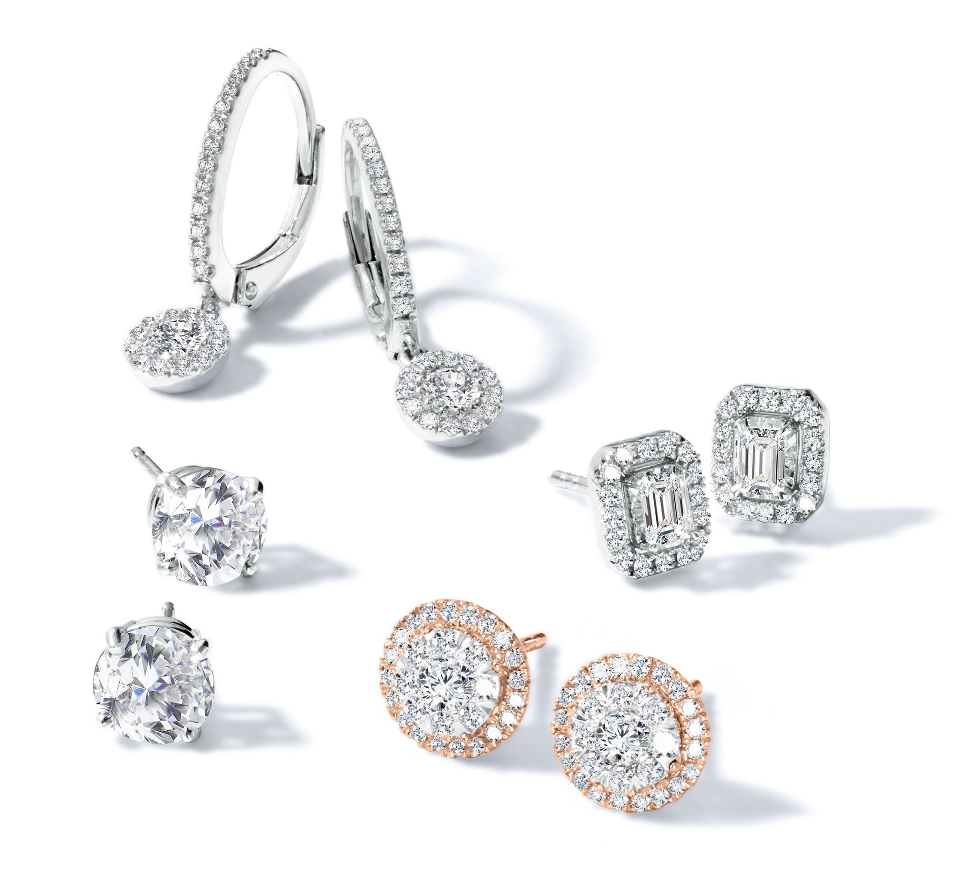 Diamond earrings, diverse styles: hoops, studs, and halo settings.