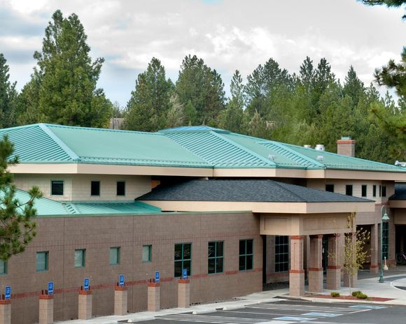 A large brick building with a green roof