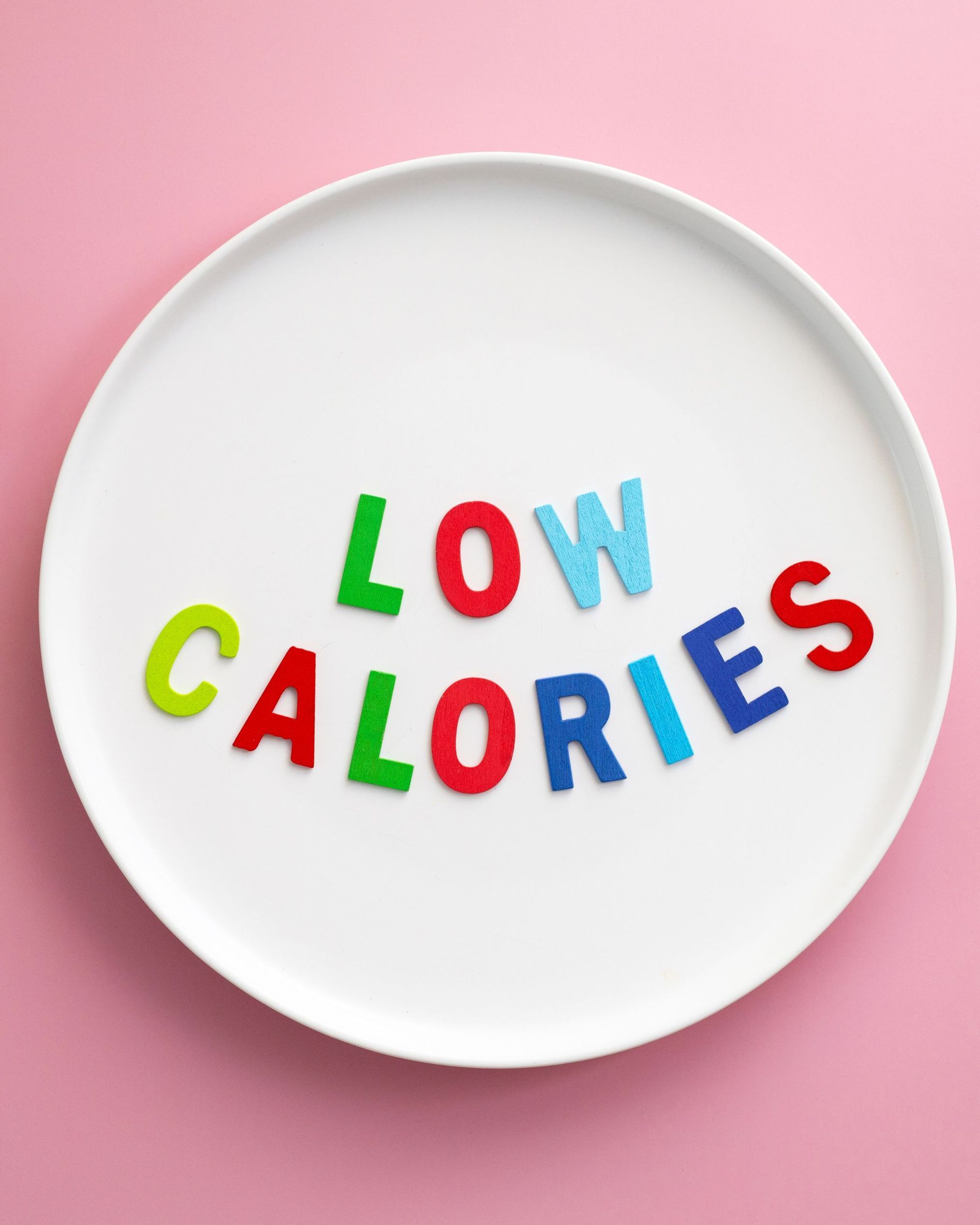 White plate on pink background with colorful 