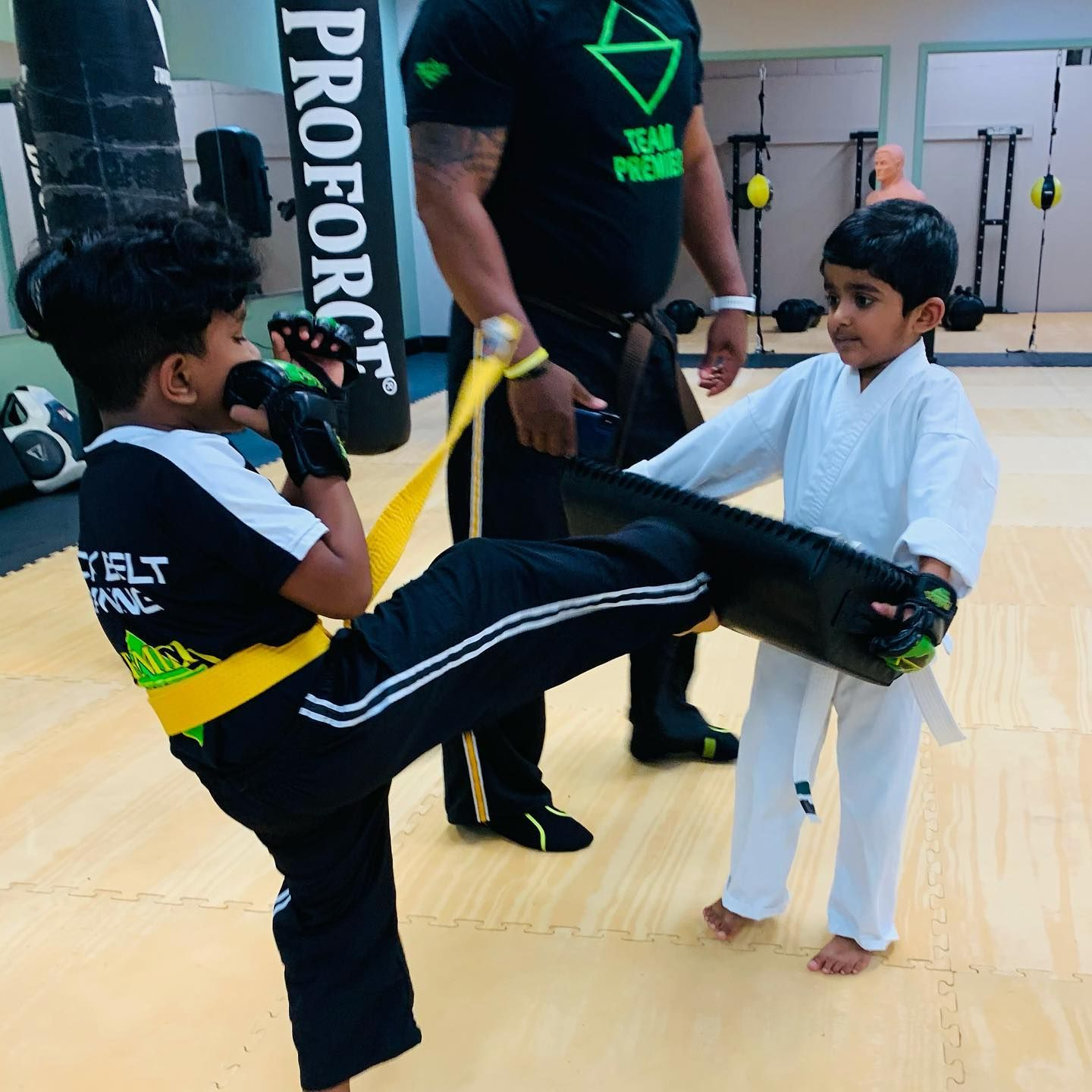 A boy and a girl are practicing taekwondo together.