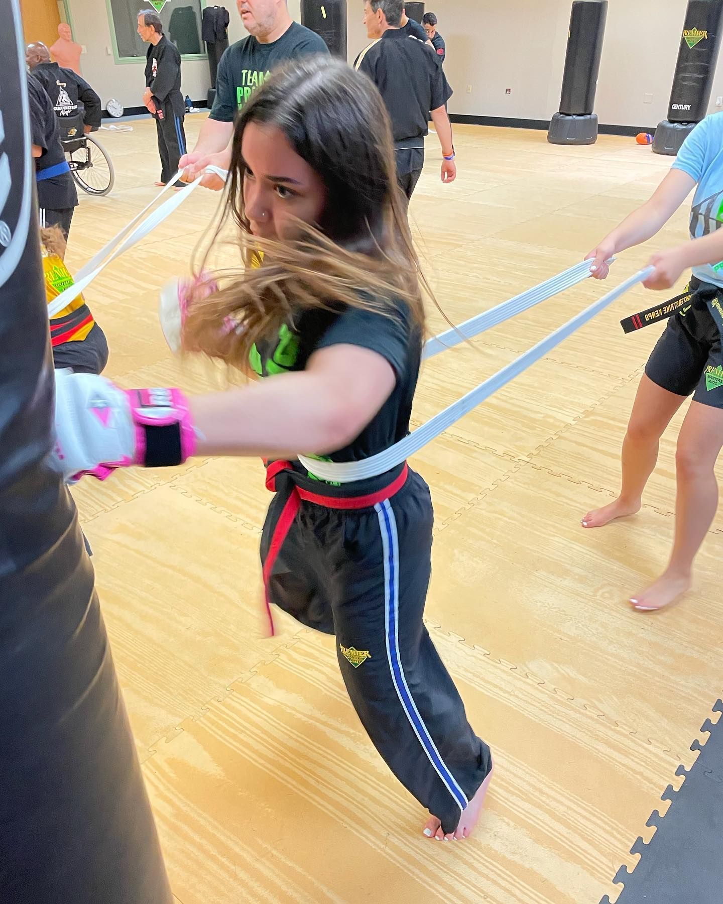A group of young boys are kneeling on the floor holding toys.