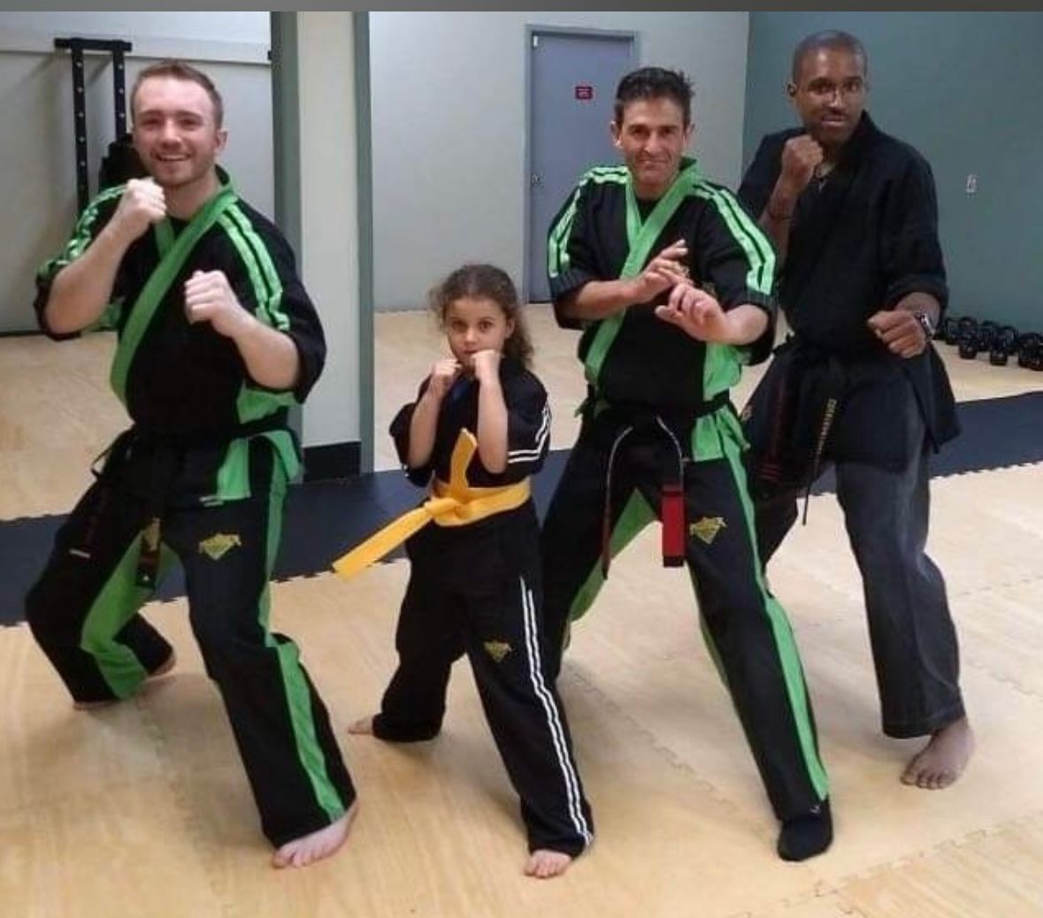 A group of young boys are boxing in a gym.