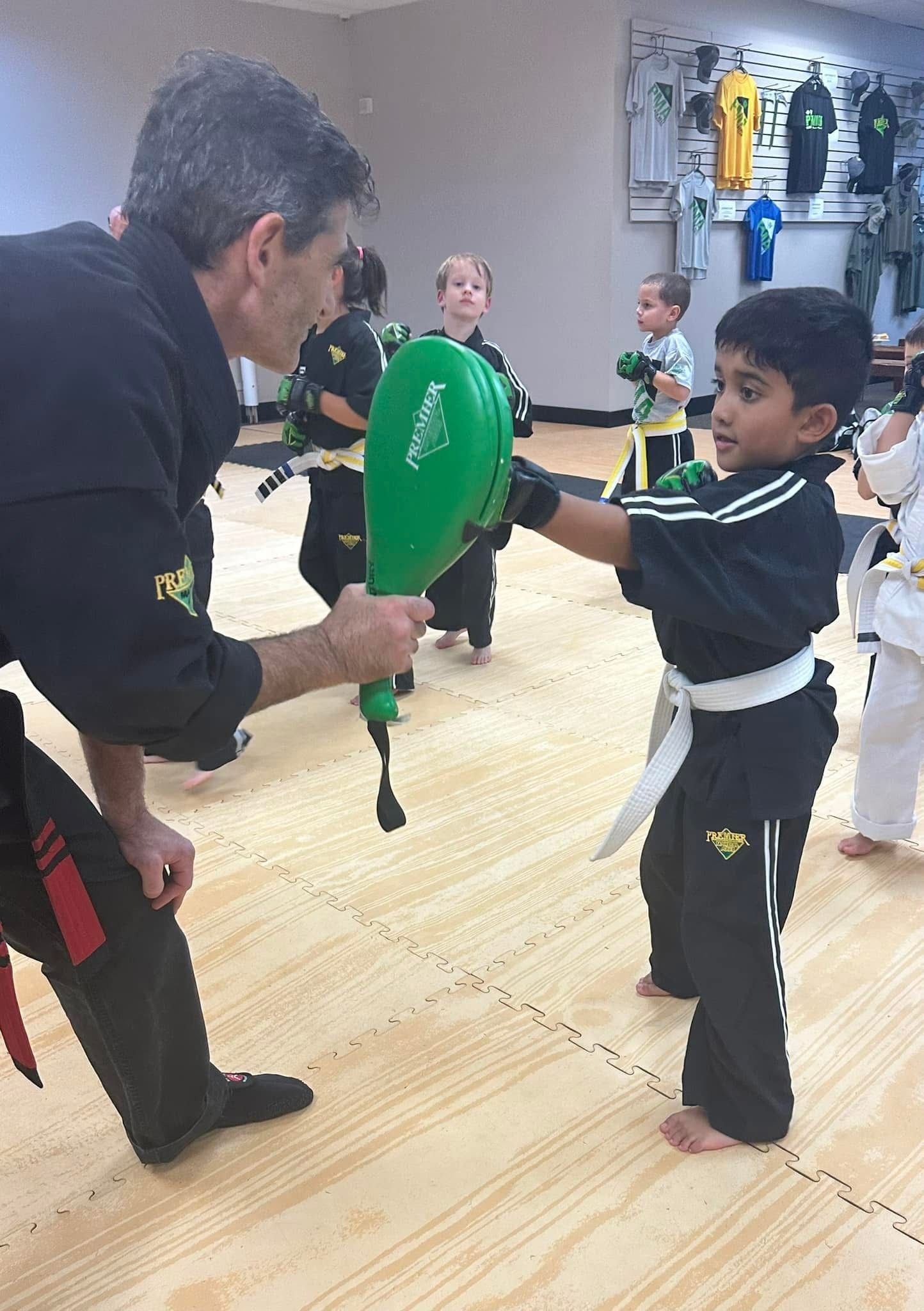 instructor teaching girl how to kick