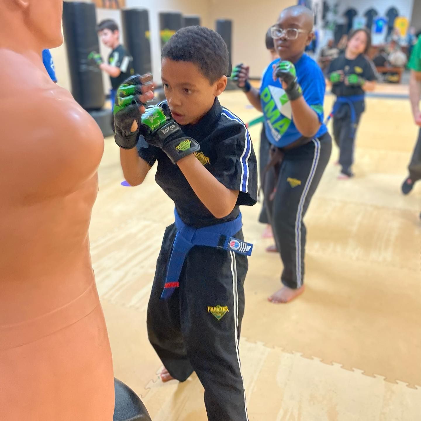 instructor teaching girl how to kick