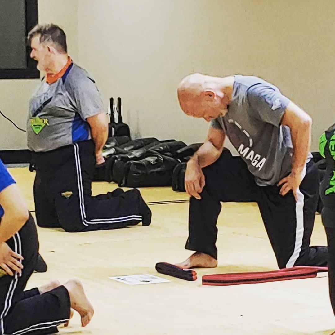 A group of men are standing in a grassy field.