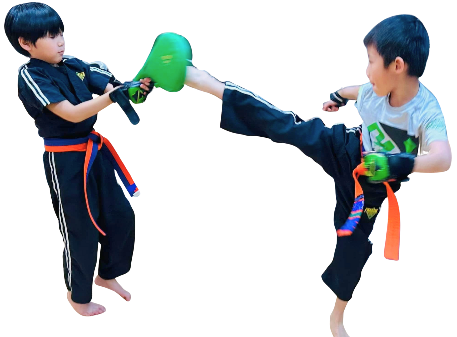 A group of kids in karate uniforms are sitting on the floor drinking water