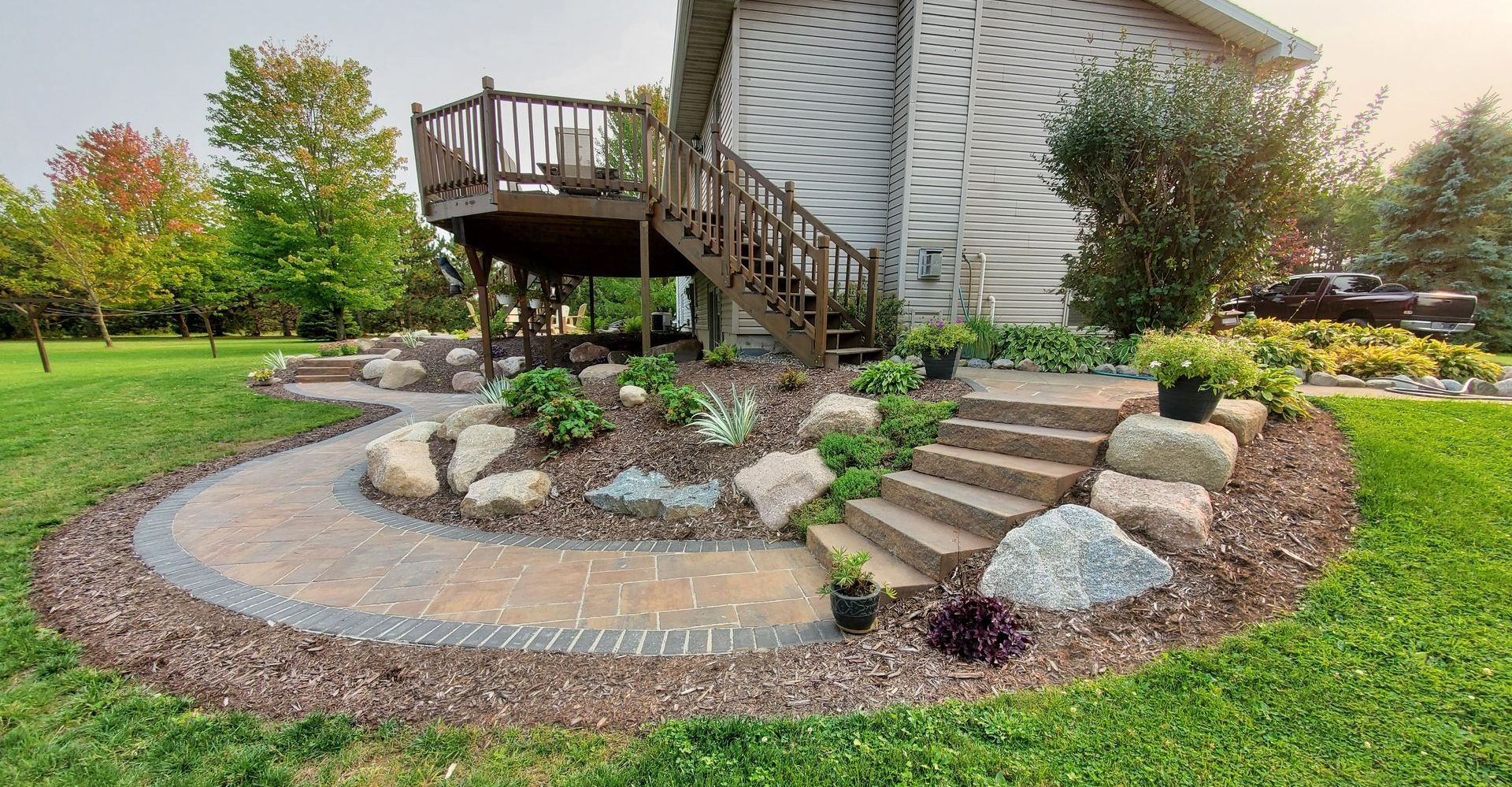 A house with a patio and stairs in front of it.