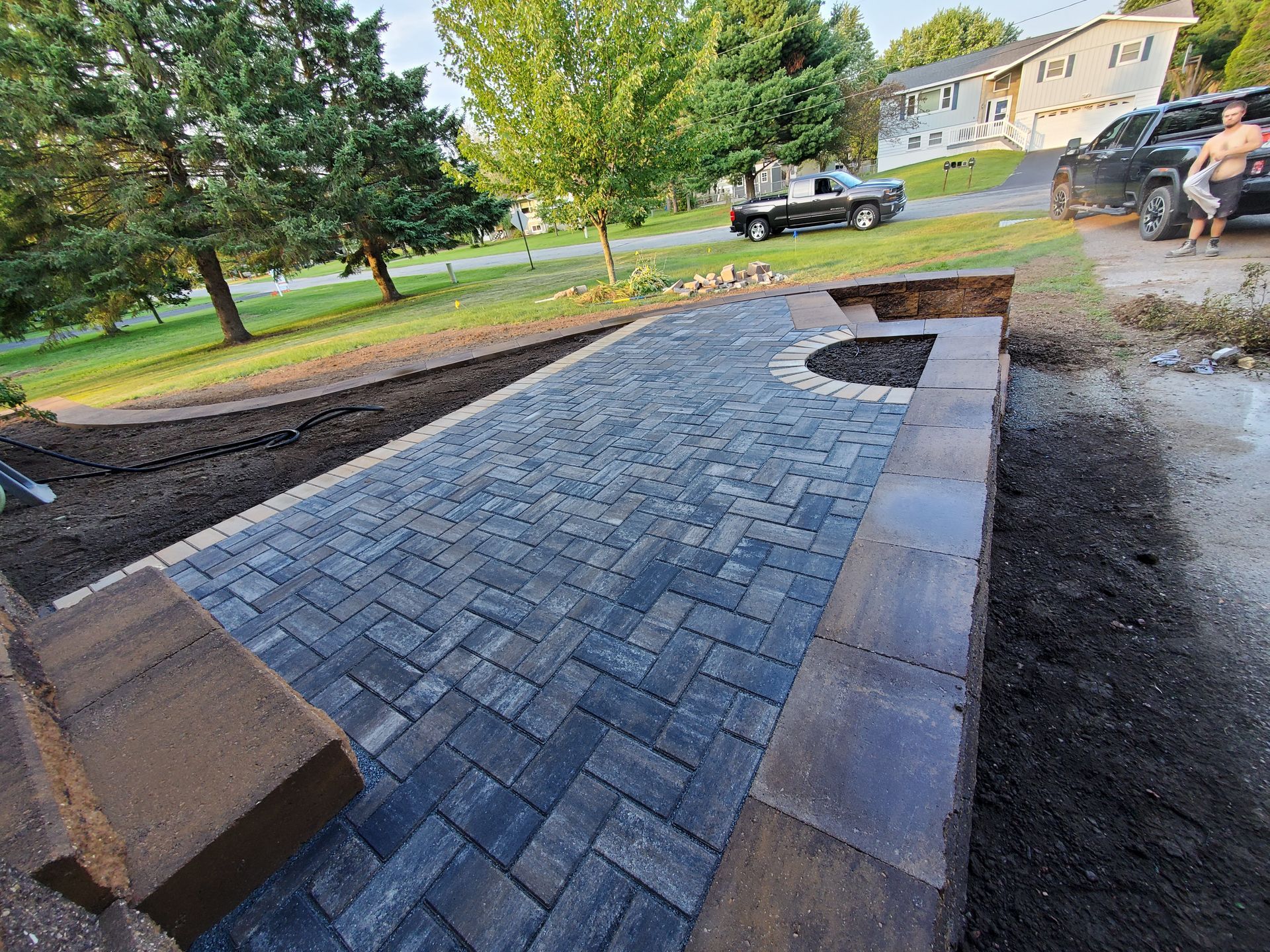A brick walkway and stairs is being built in front of a house in Weston, Wisconsin