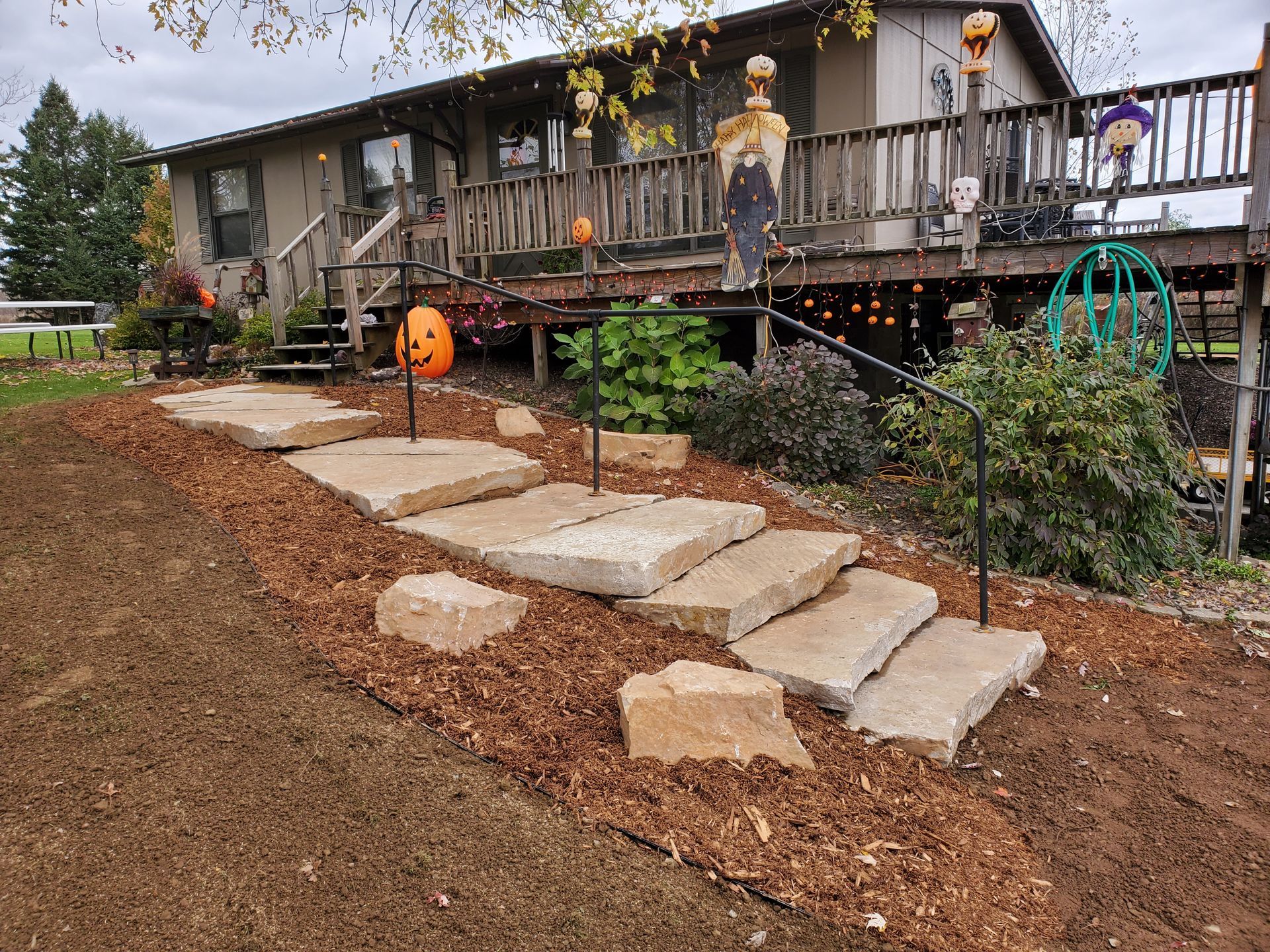 A house with a walkway and stairs leading to it