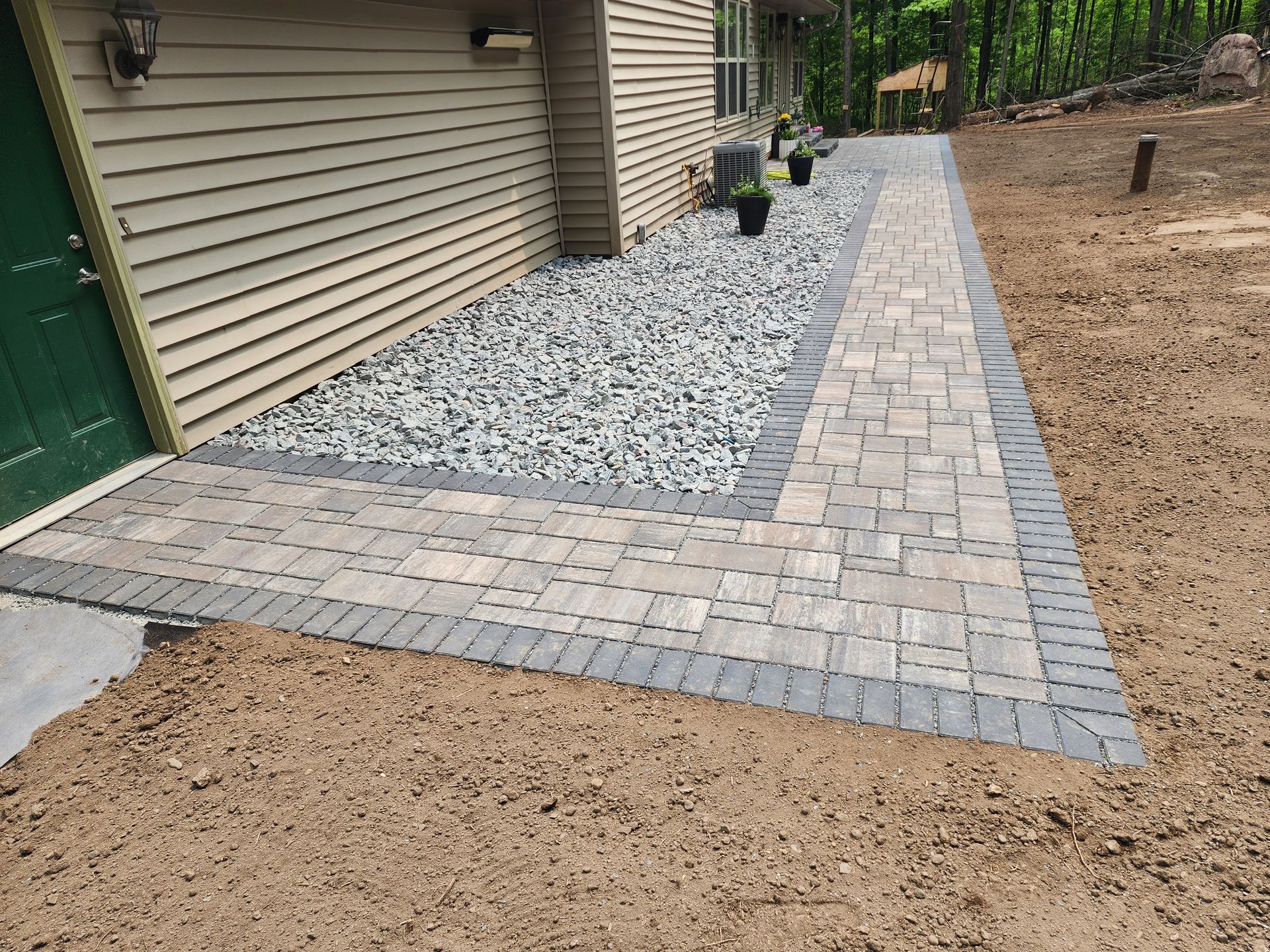 A brick walkway is being built in front of a house in Weston, Wisconsin