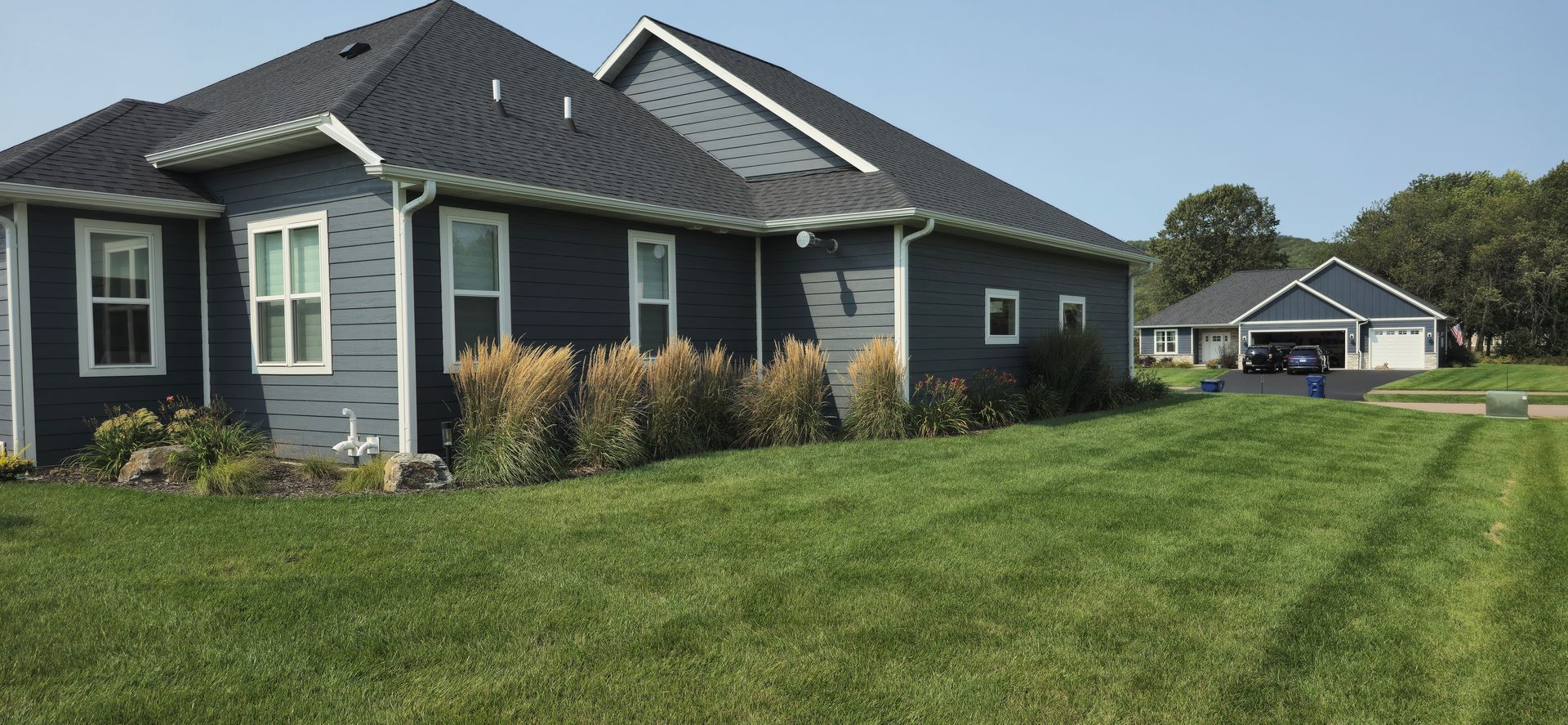 A large house with a lush green lawn in front of it.