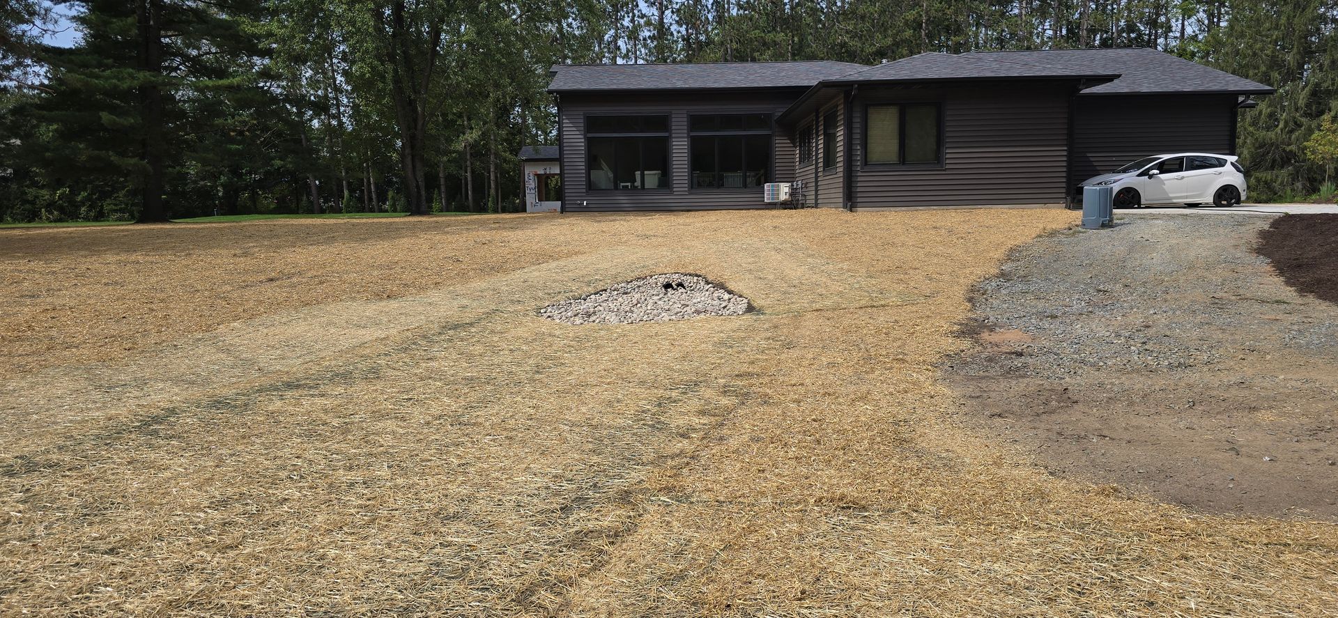 A house with a car parked in front of it
