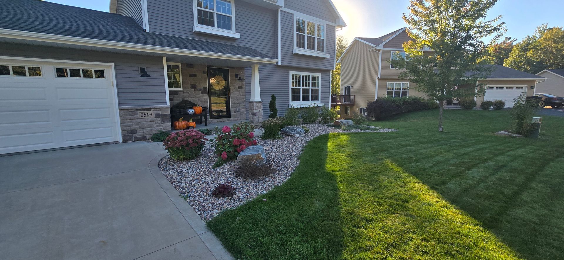 A large house with a lush green lawn in front of it.