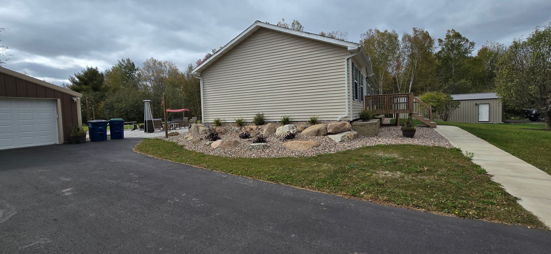 A large white house with a garage and a driveway in front of it.