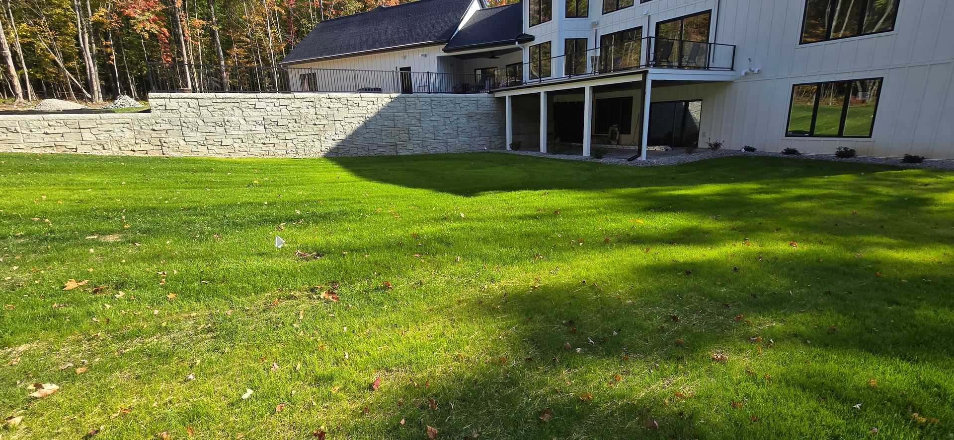 A large white house with a large lawn in front of it.