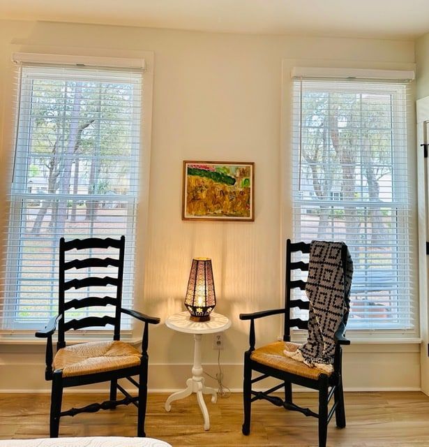 There are two chairs and a table in the room.