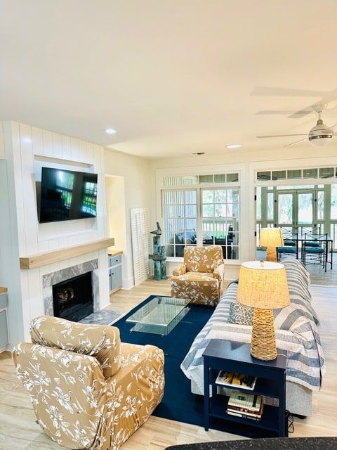 A living room with a couch and chairs and a flat screen tv