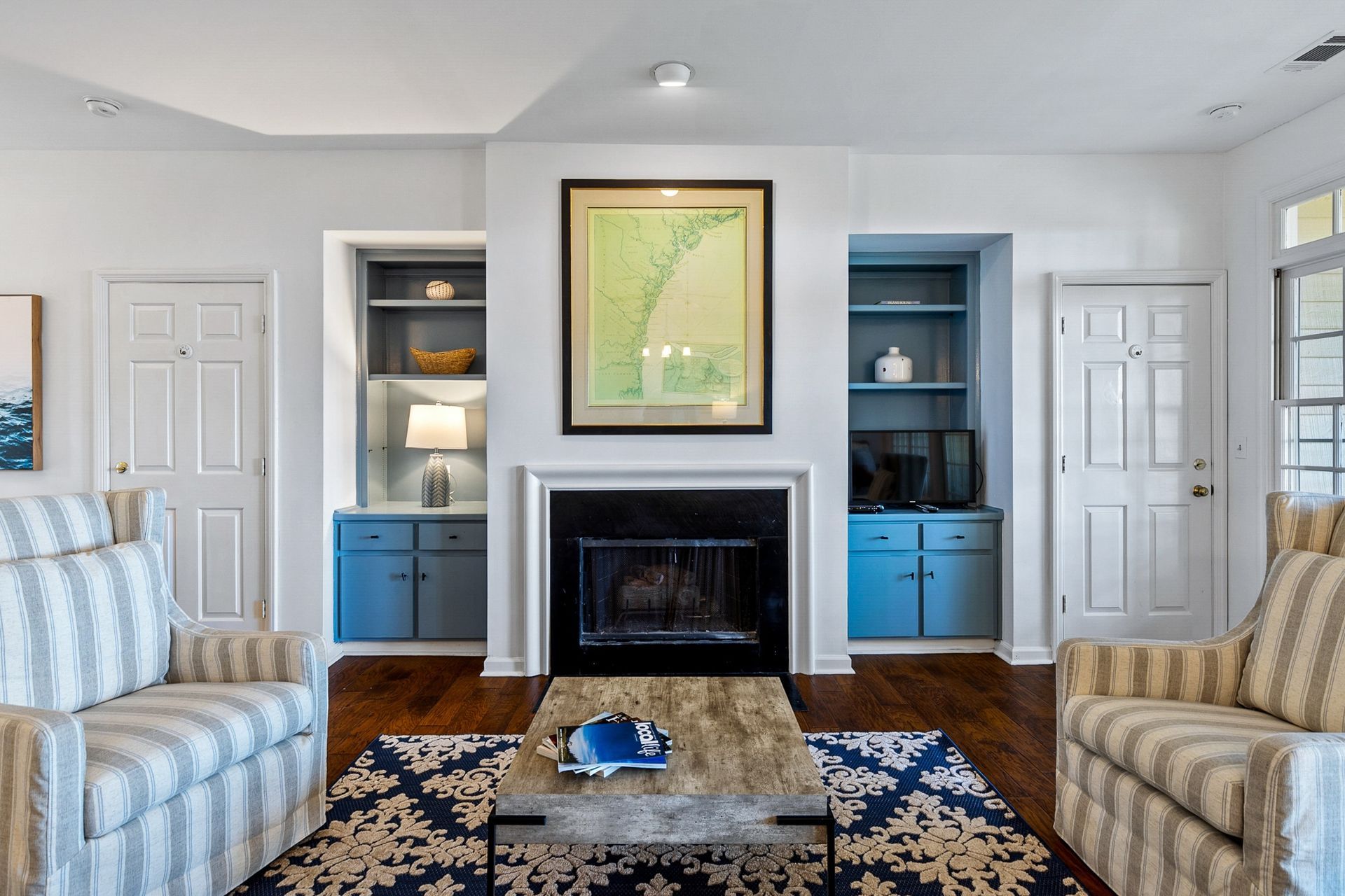 There is a fireplace in the middle of the living room.