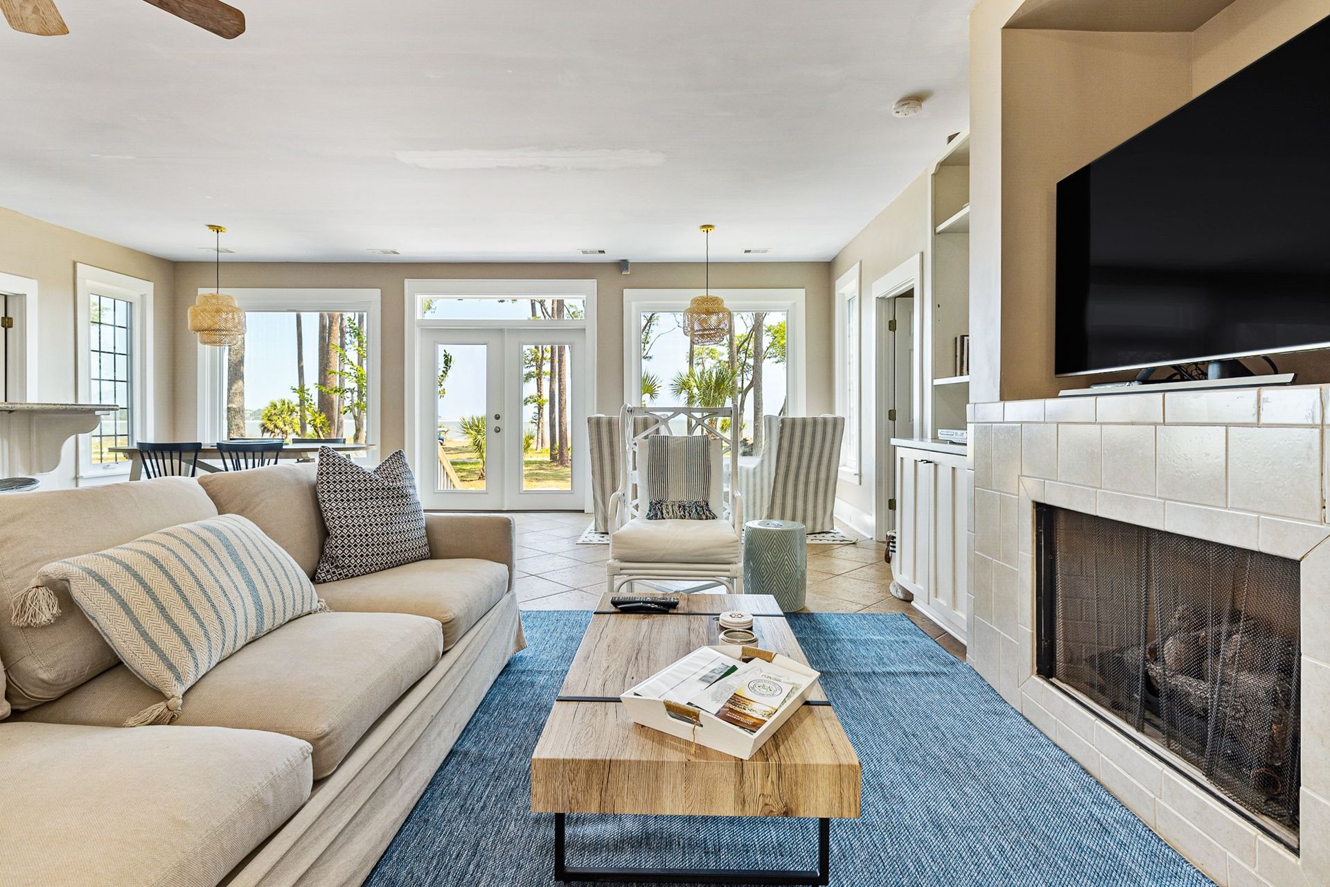 A living room with a couch , coffee table , fireplace and television.
