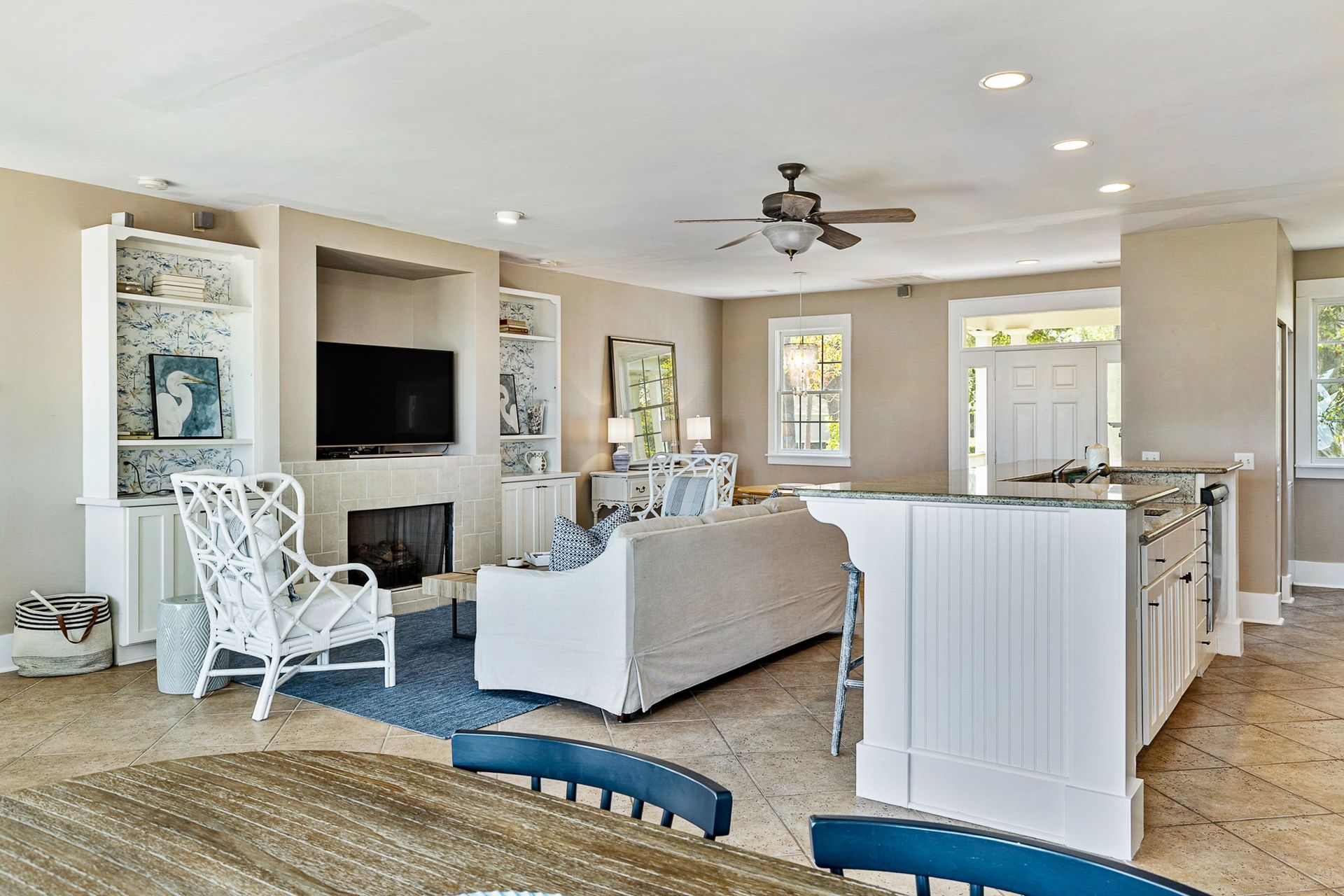 A living room with a couch , chair , table and television.