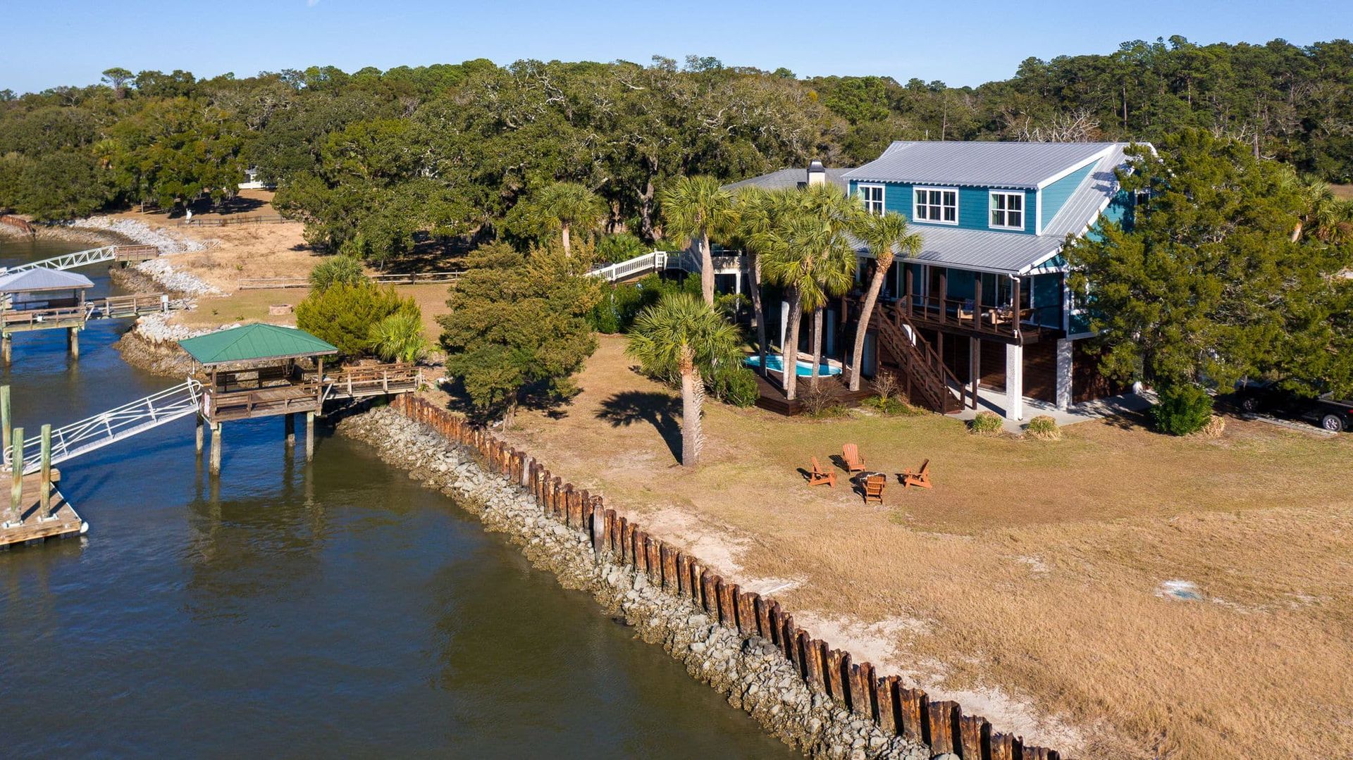 An aerial view of a house next to a body of water.