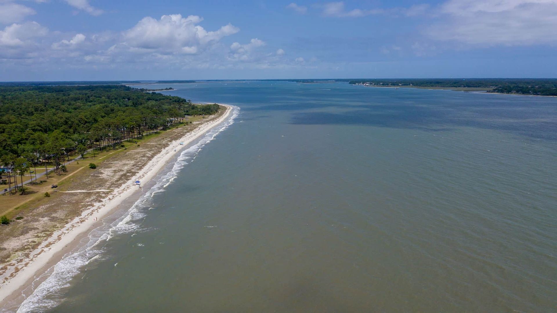 An aerial view of a beach and a body of water.