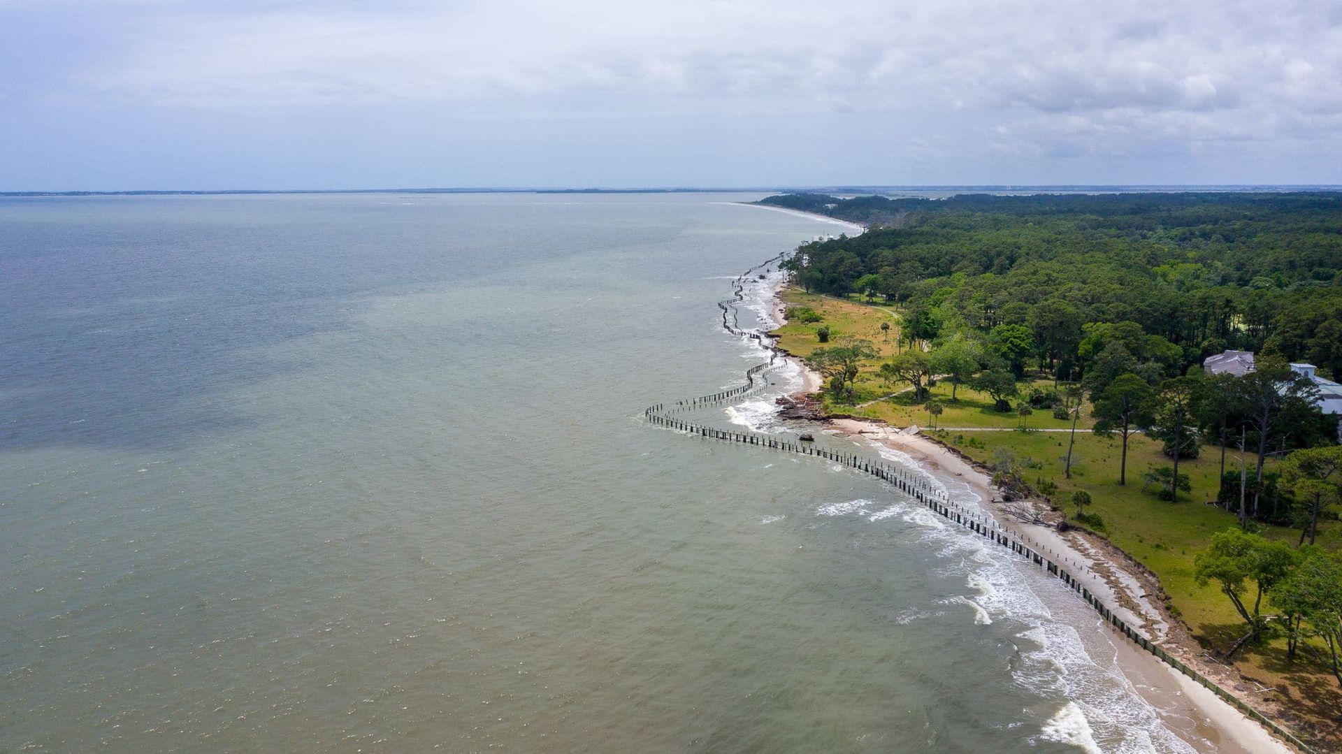 An aerial view of a large body of water surrounded by trees.