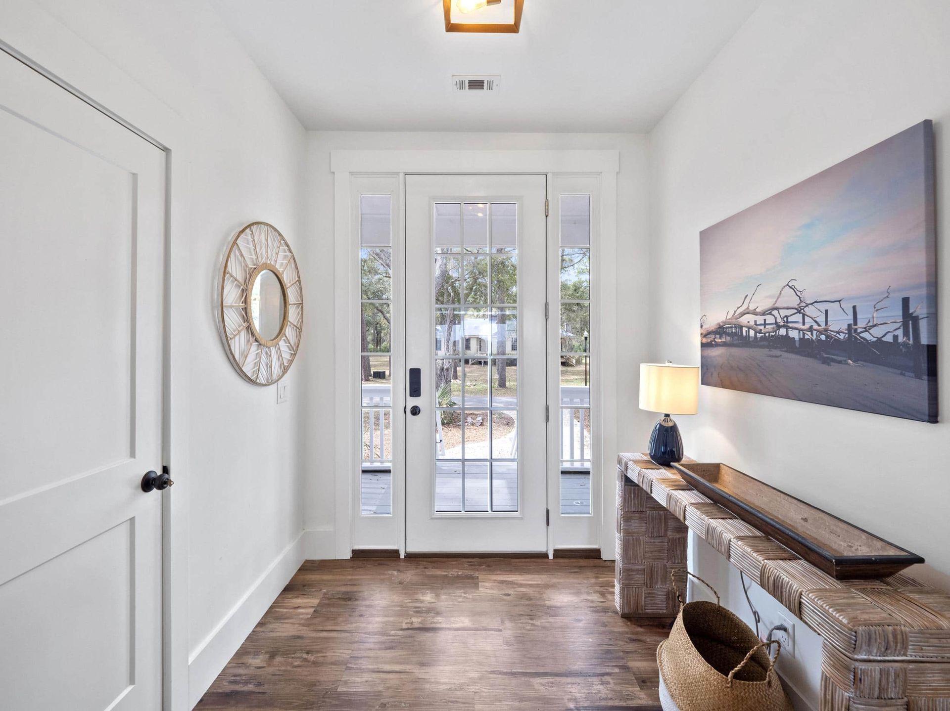 A hallway with a table and a painting on the wall.