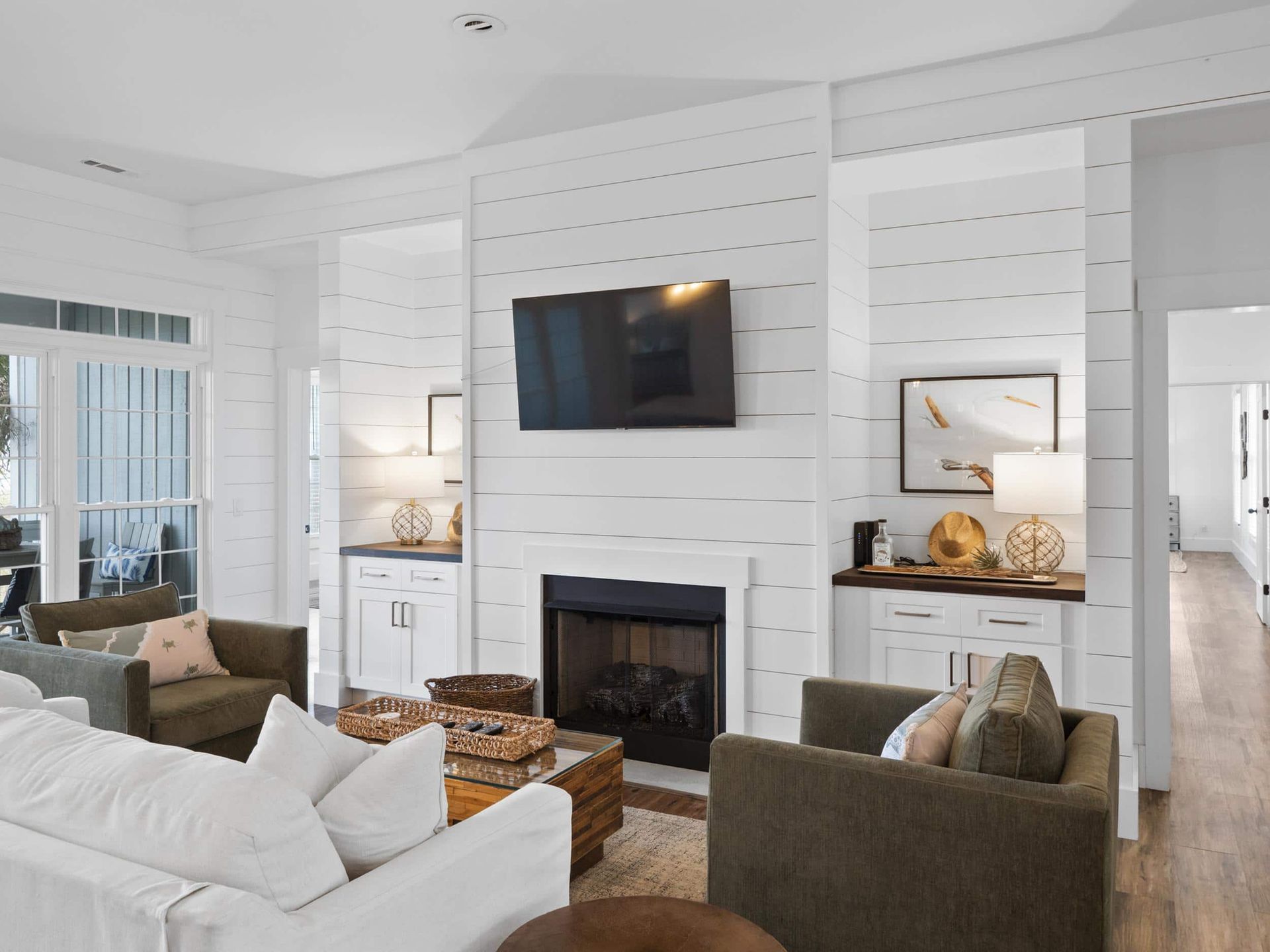 A living room with a fireplace and a flat screen tv