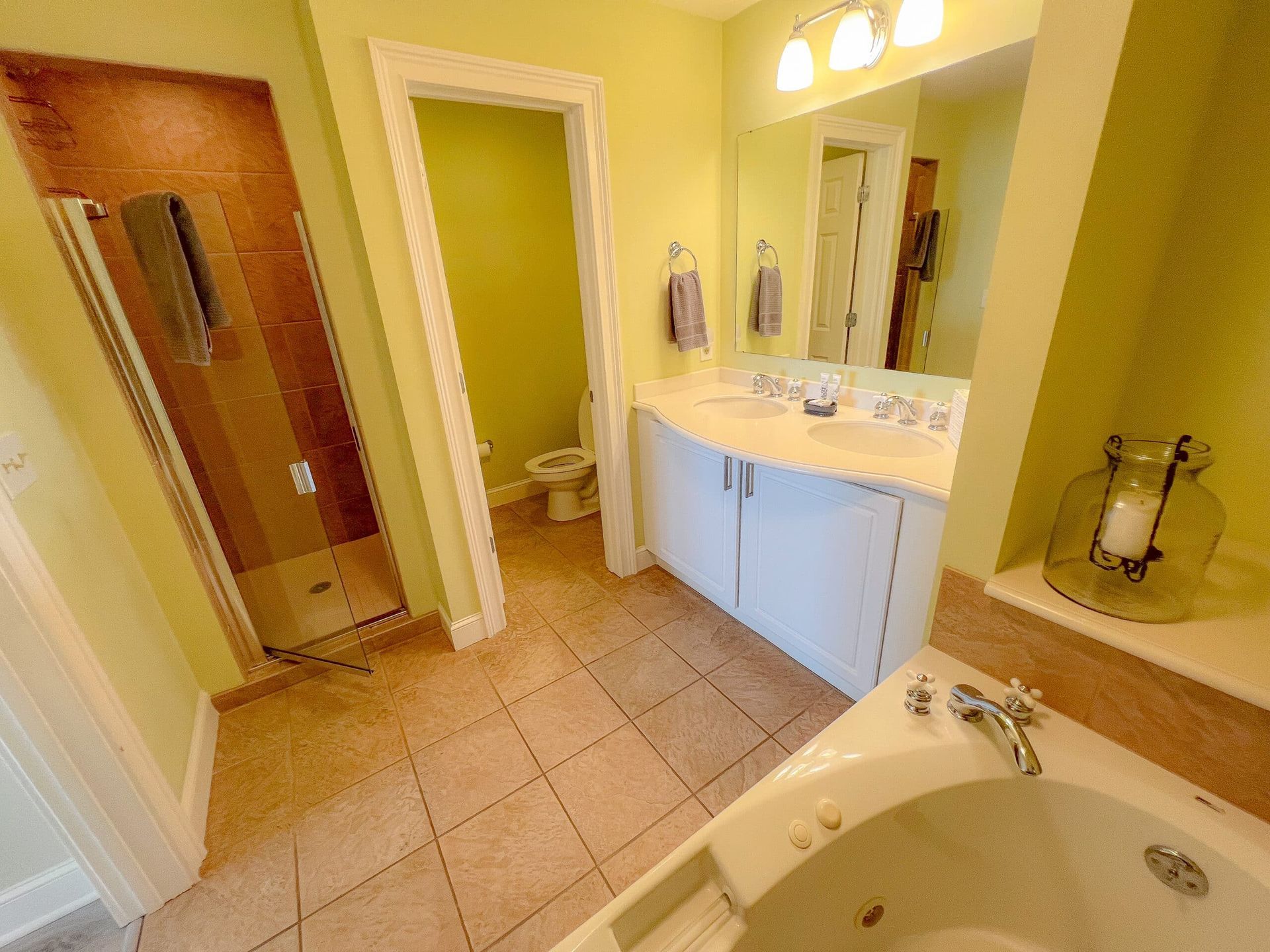 A bathroom with a tub , sink , toilet and shower