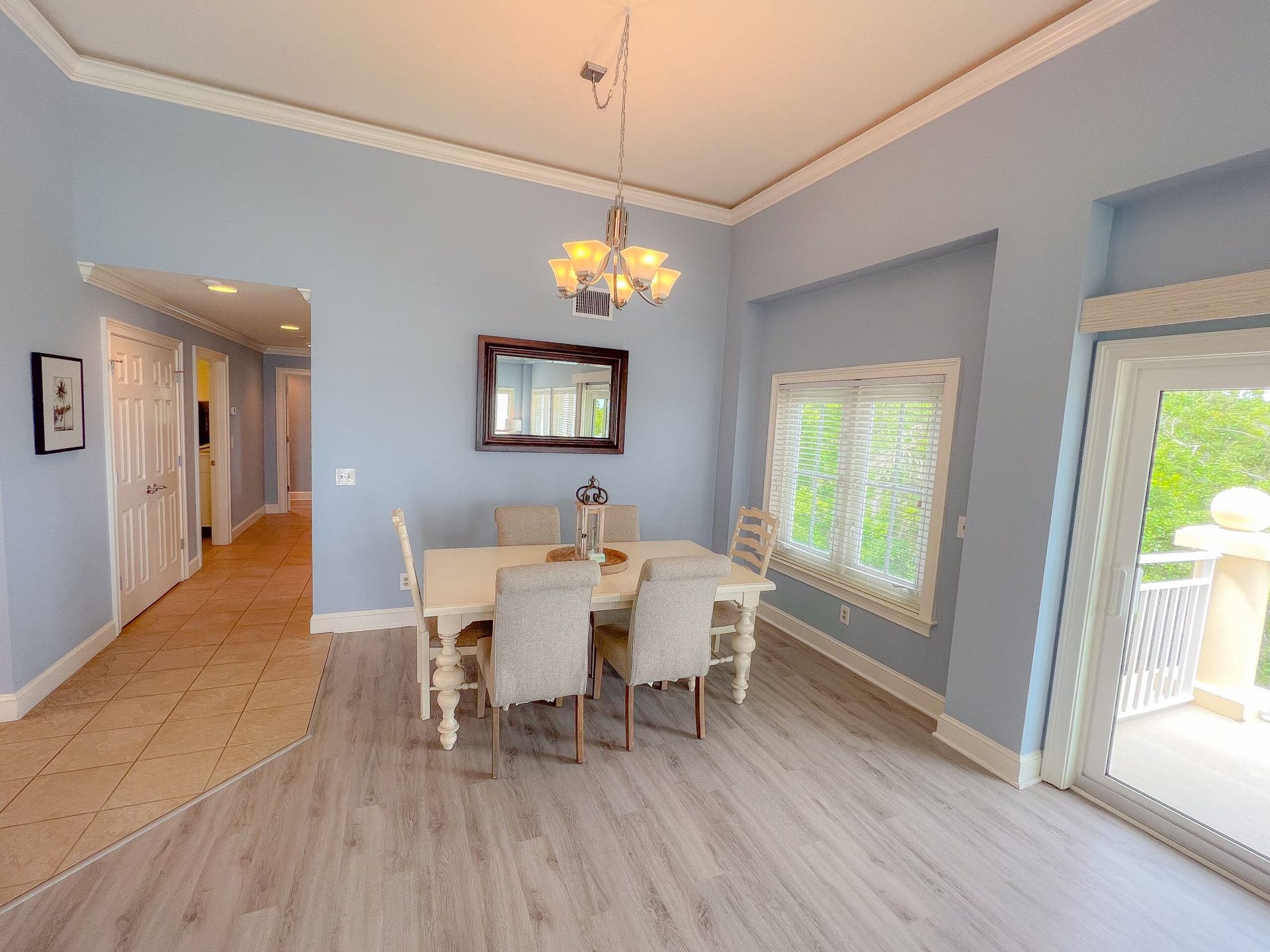 A dining room with a table and chairs and a chandelier