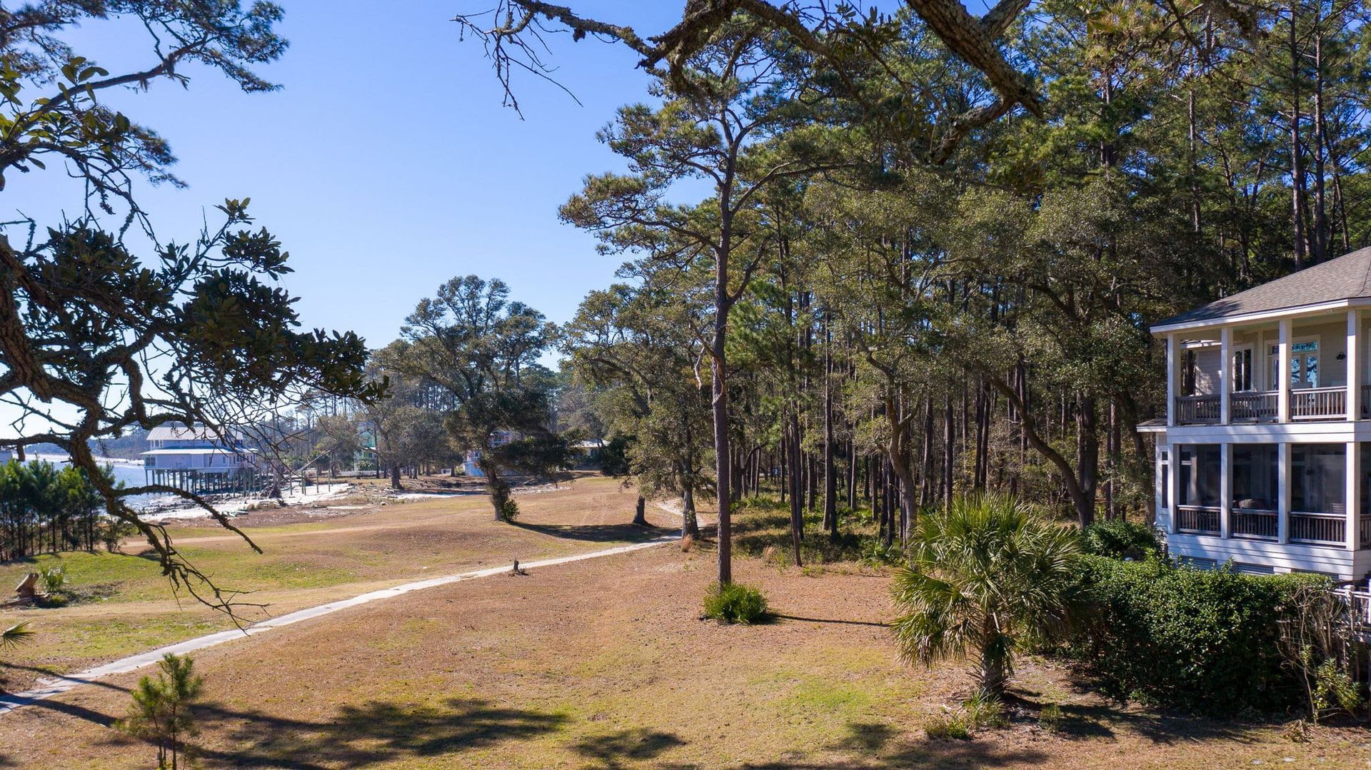 A house in the middle of a field with trees in the background