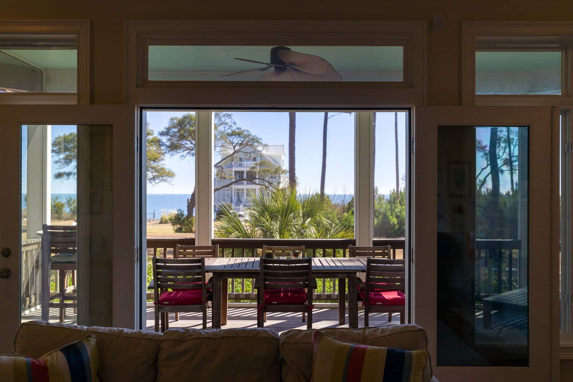 A living room with a couch and a view of the ocean