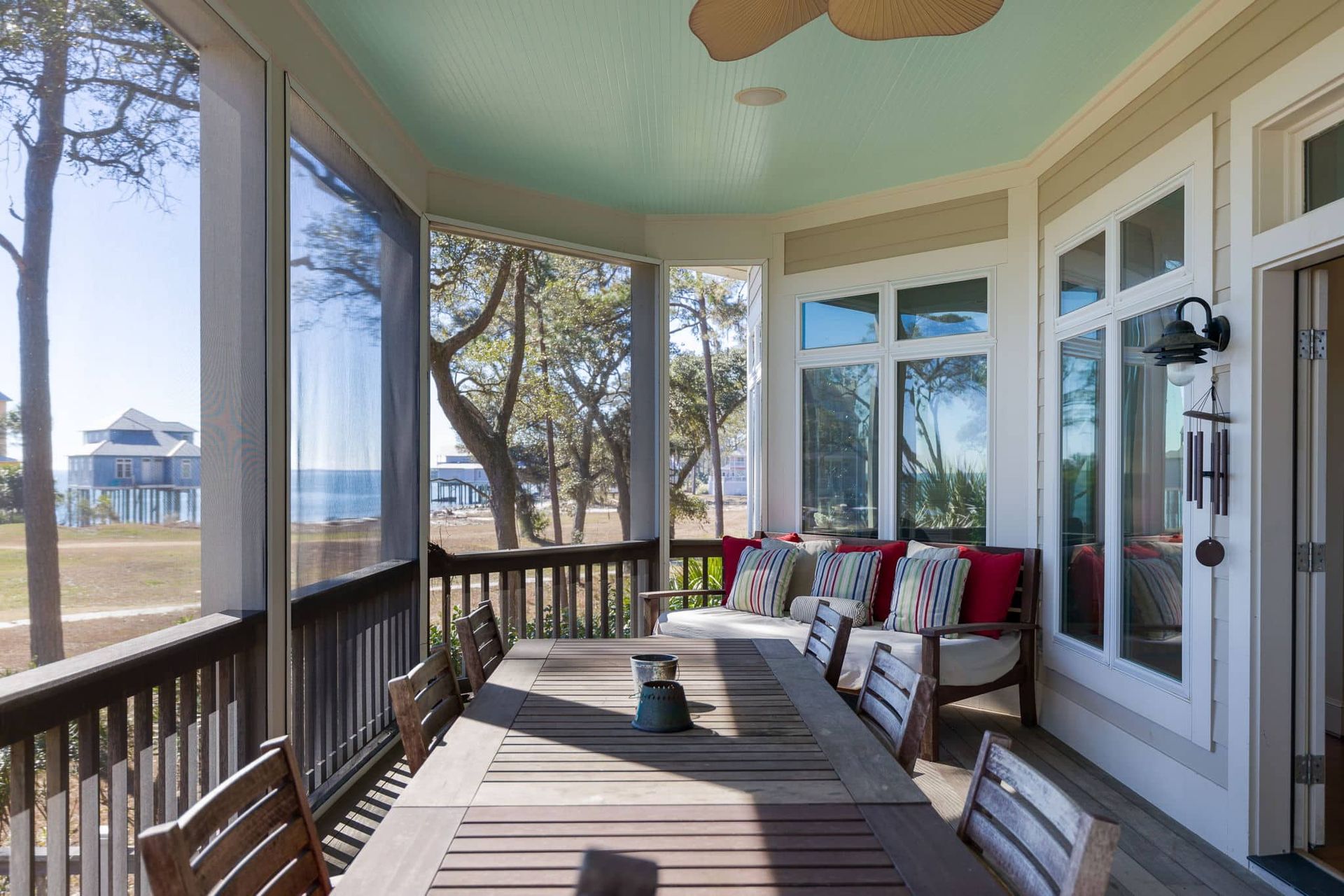 A screened in porch with a table and chairs