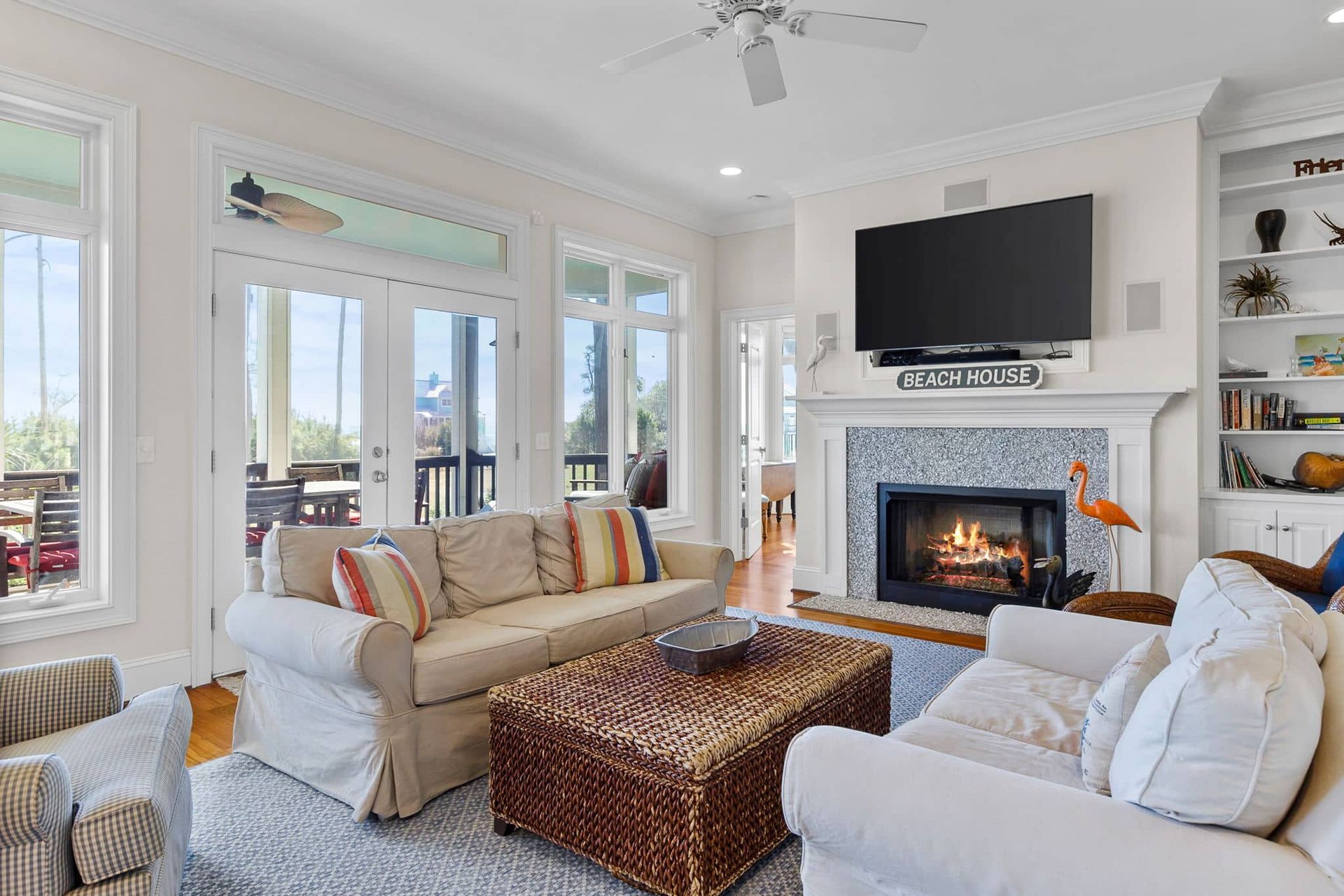 A living room with a fireplace and a flat screen tv.