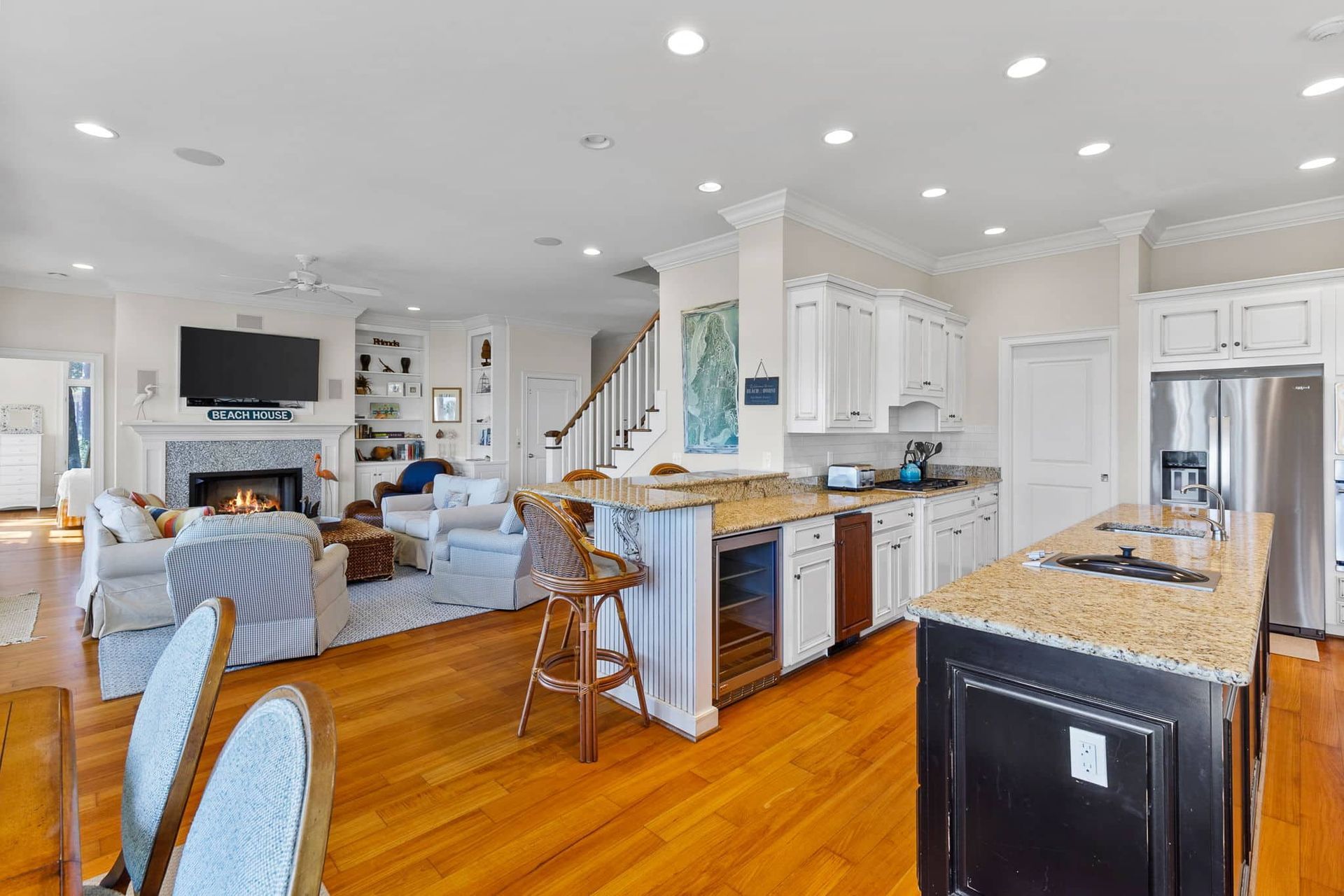 A kitchen with granite counter tops and stainless steel appliances in a large house.