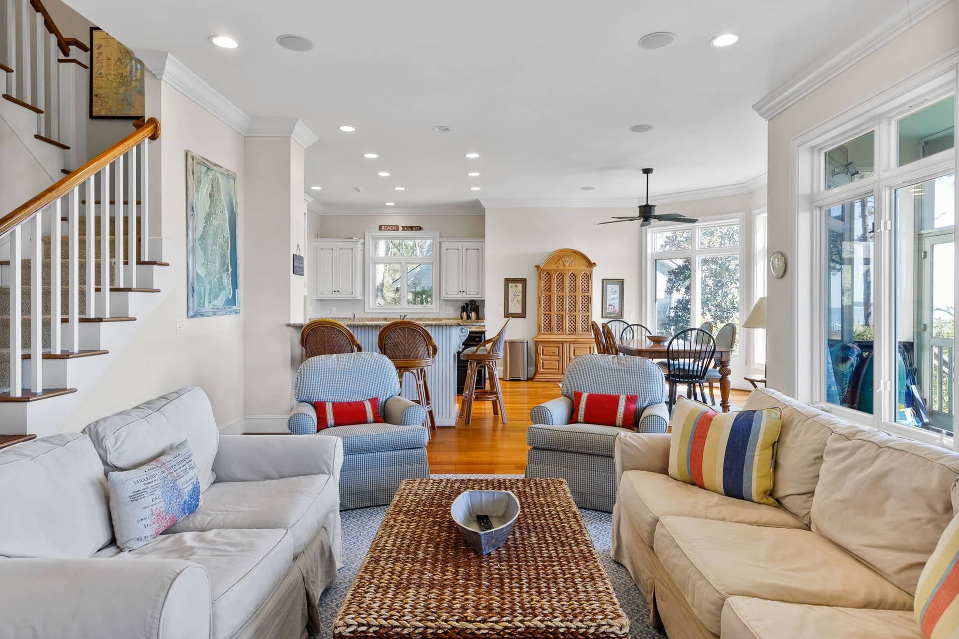 A living room filled with furniture and a wicker coffee table.